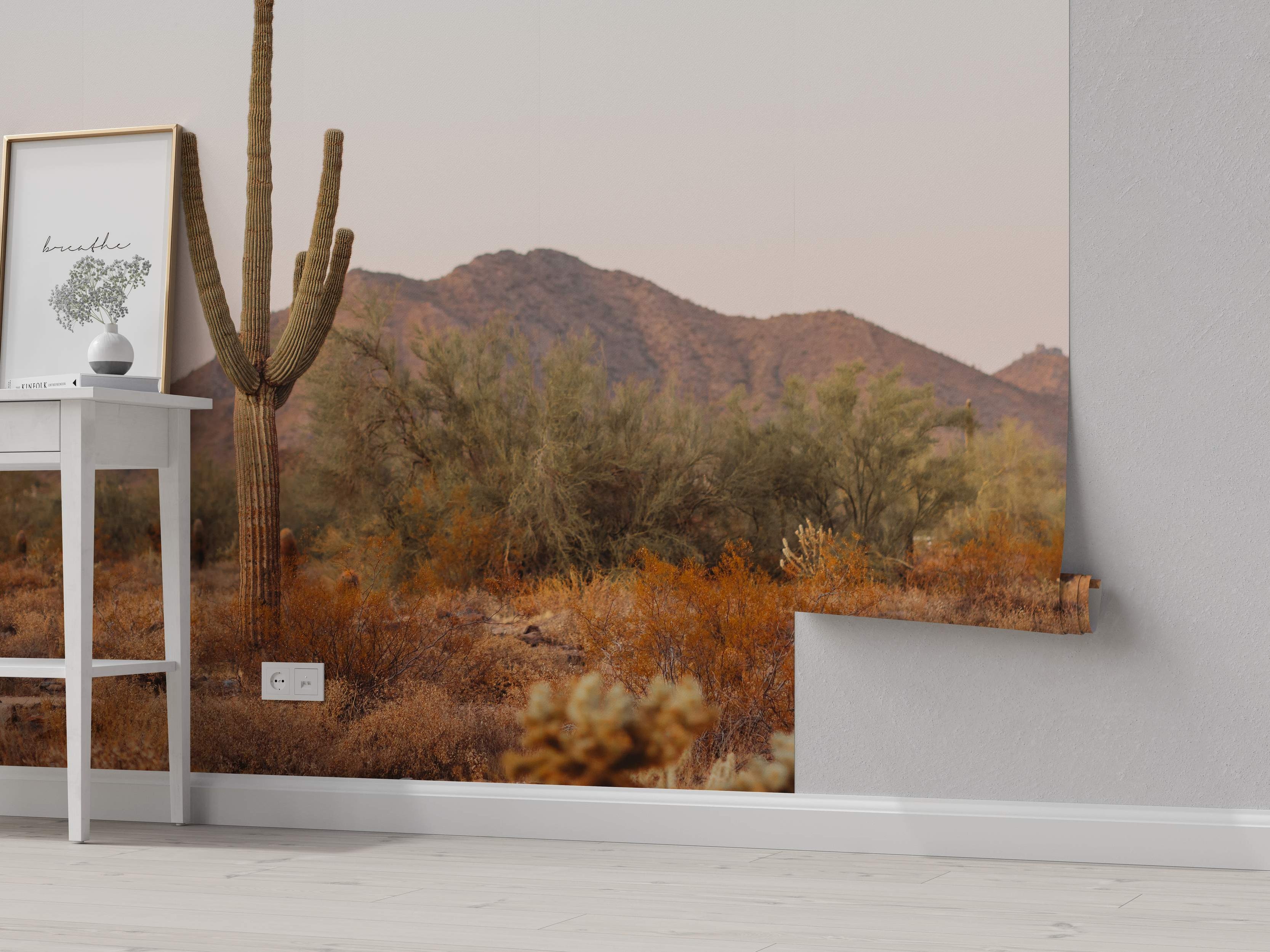 Desert landscape mural with cactus and mountains in brown tones