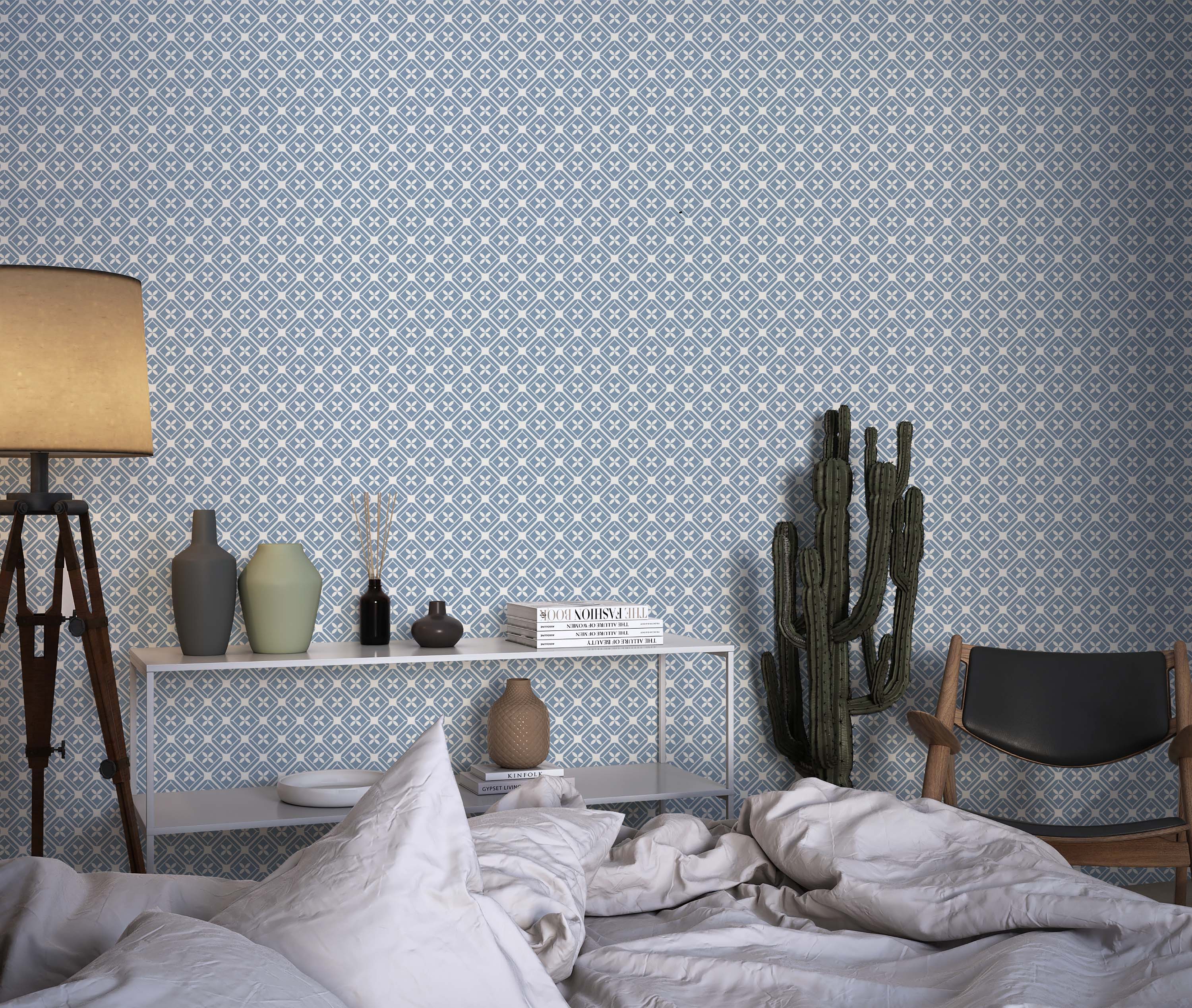 A geometric wallpaper in blue and white, featuring a repeating pattern of diamonds, each centered with a white quatrefoil motif.