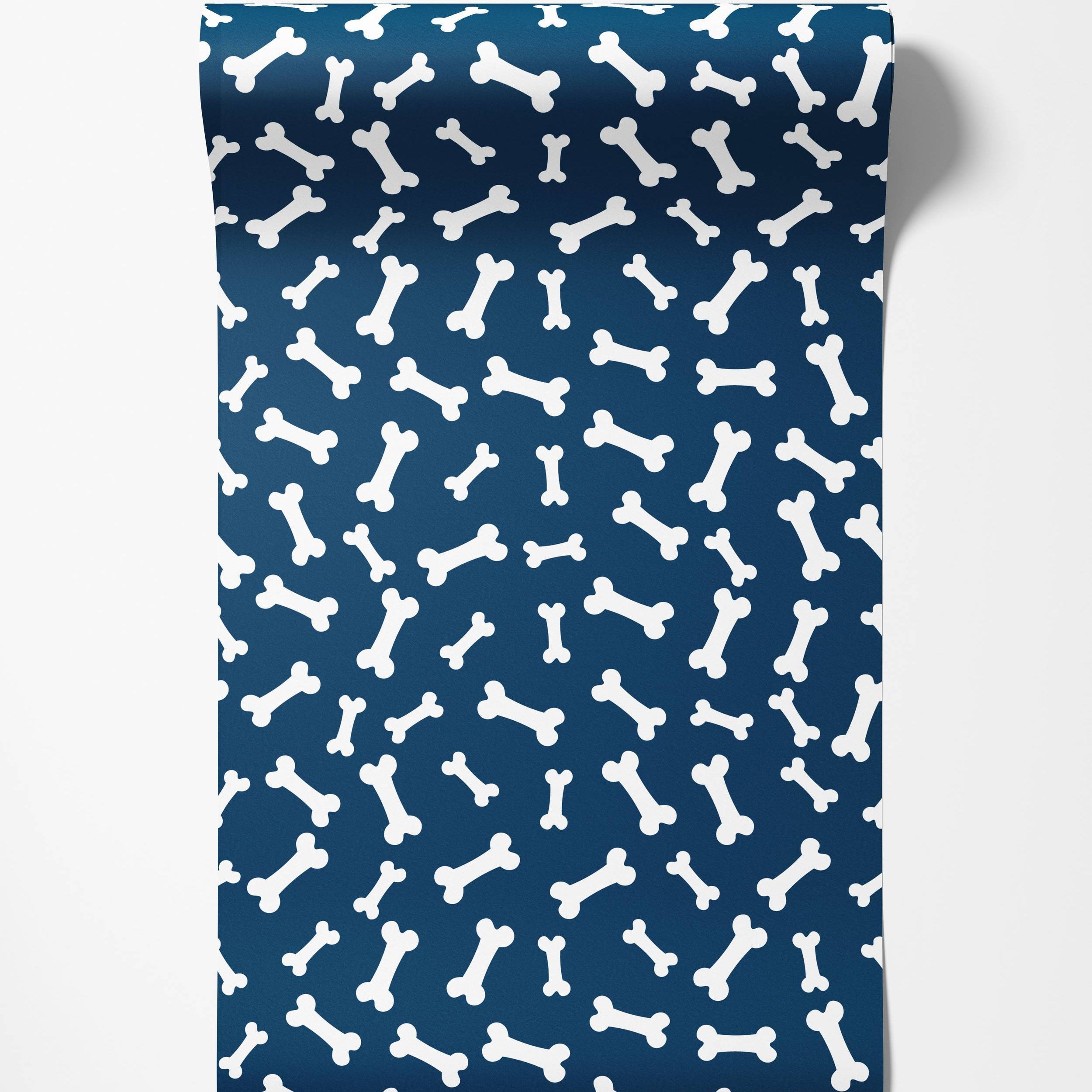 A playful wallpaper featuring a scattered pattern of white cartoon dog bones on a dark blue background.