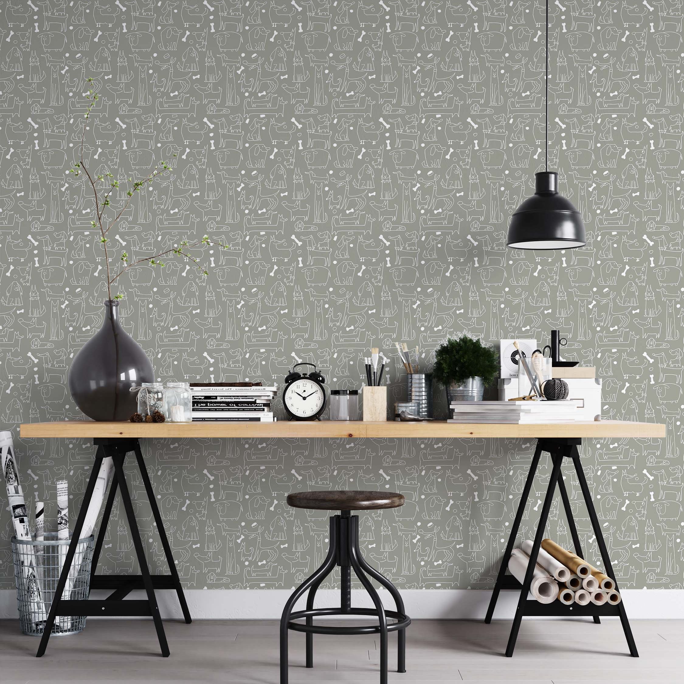 Whimsical wallpaper featuring a pattern of white, hand-drawn cartoon dogs and bones on a solid gray background.