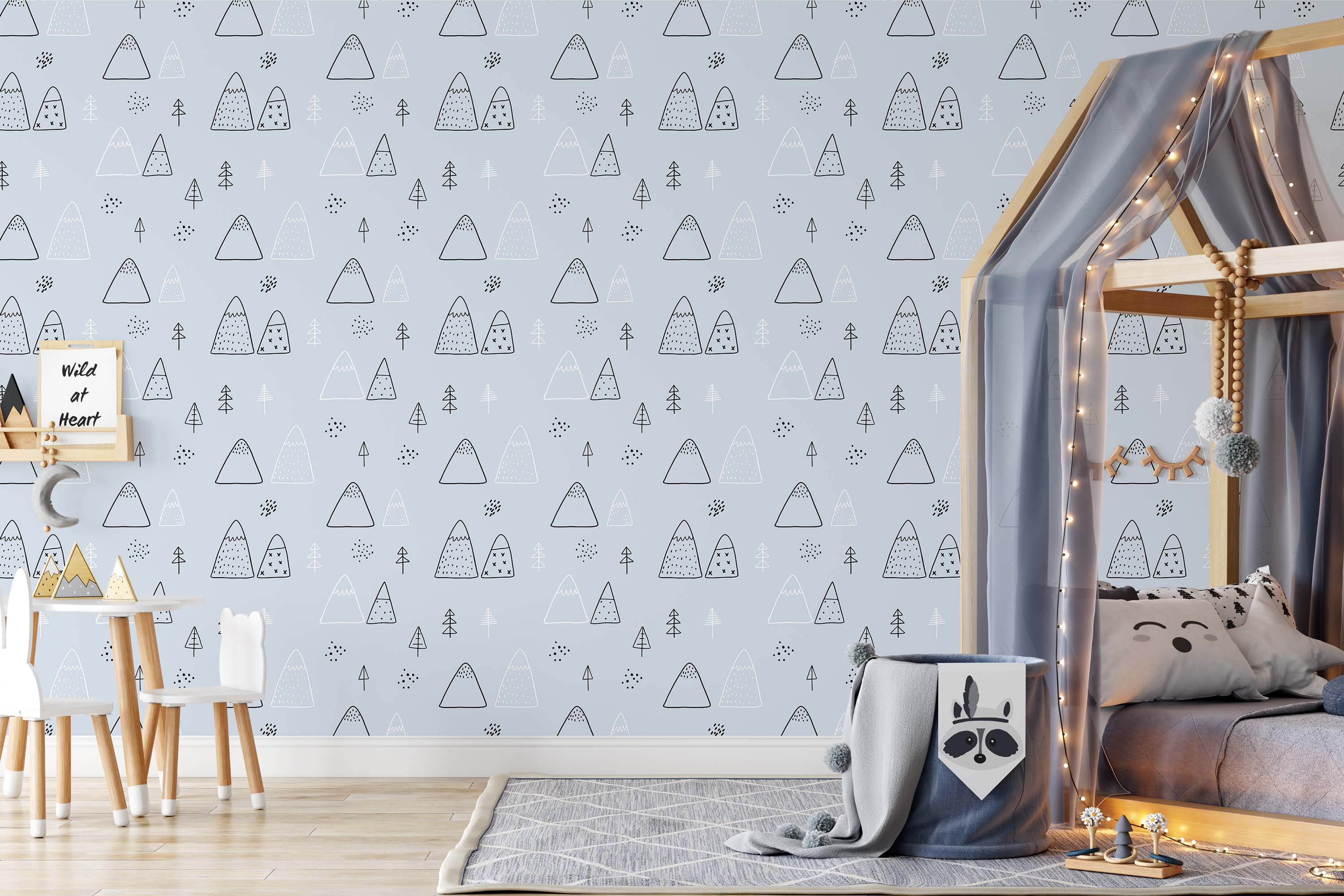 Pale blue wallpaper with a repeating Scandinavian-style pattern of doodle mountains, trees, and dots in black and white.