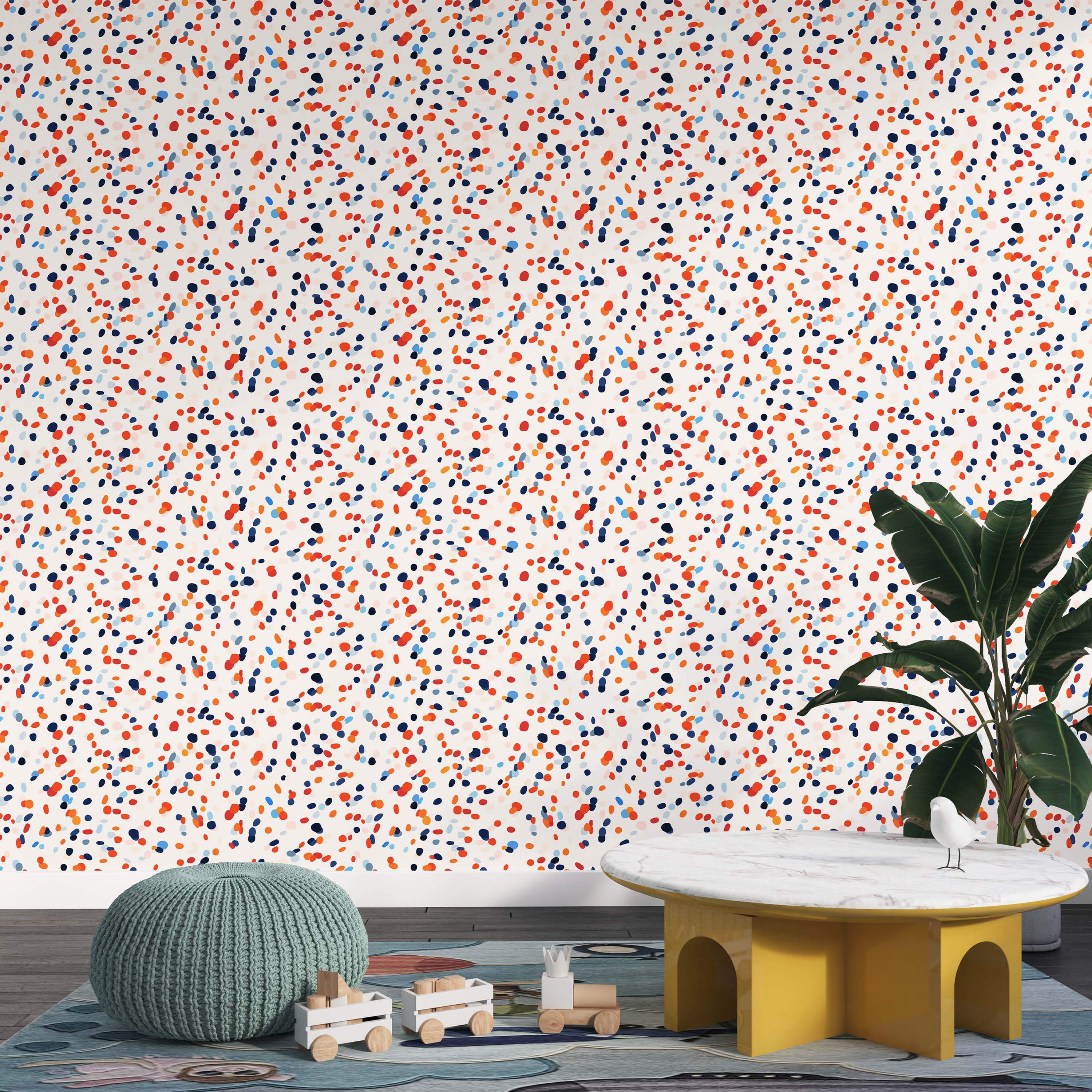 Wallpaper featuring scattered dots in red, orange, dark blue, and light blue on an off-white field.