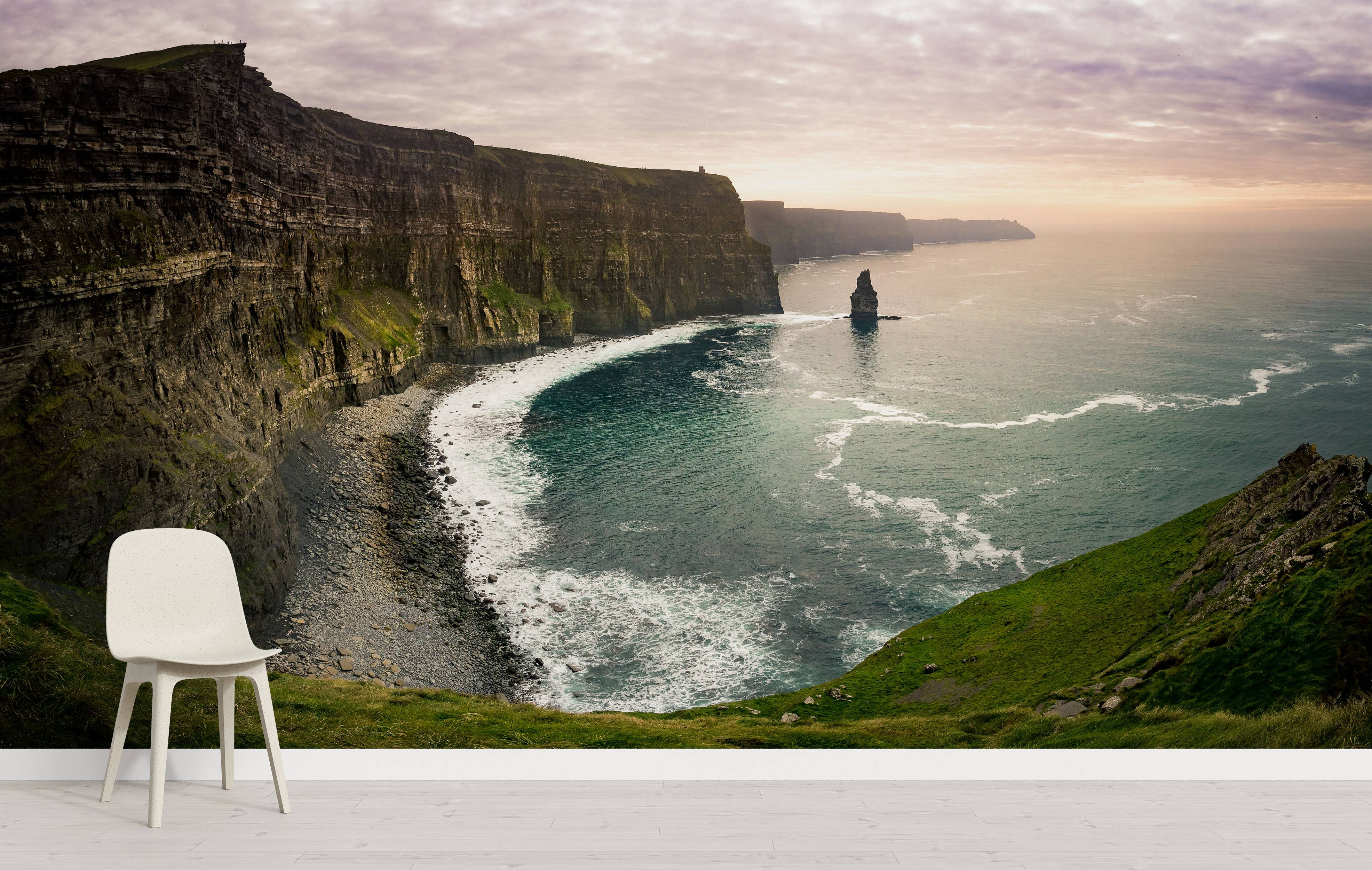 A photorealistic mural of dramatic sea cliffs meeting a turquoise ocean under a soft, cloudy sunset sky.