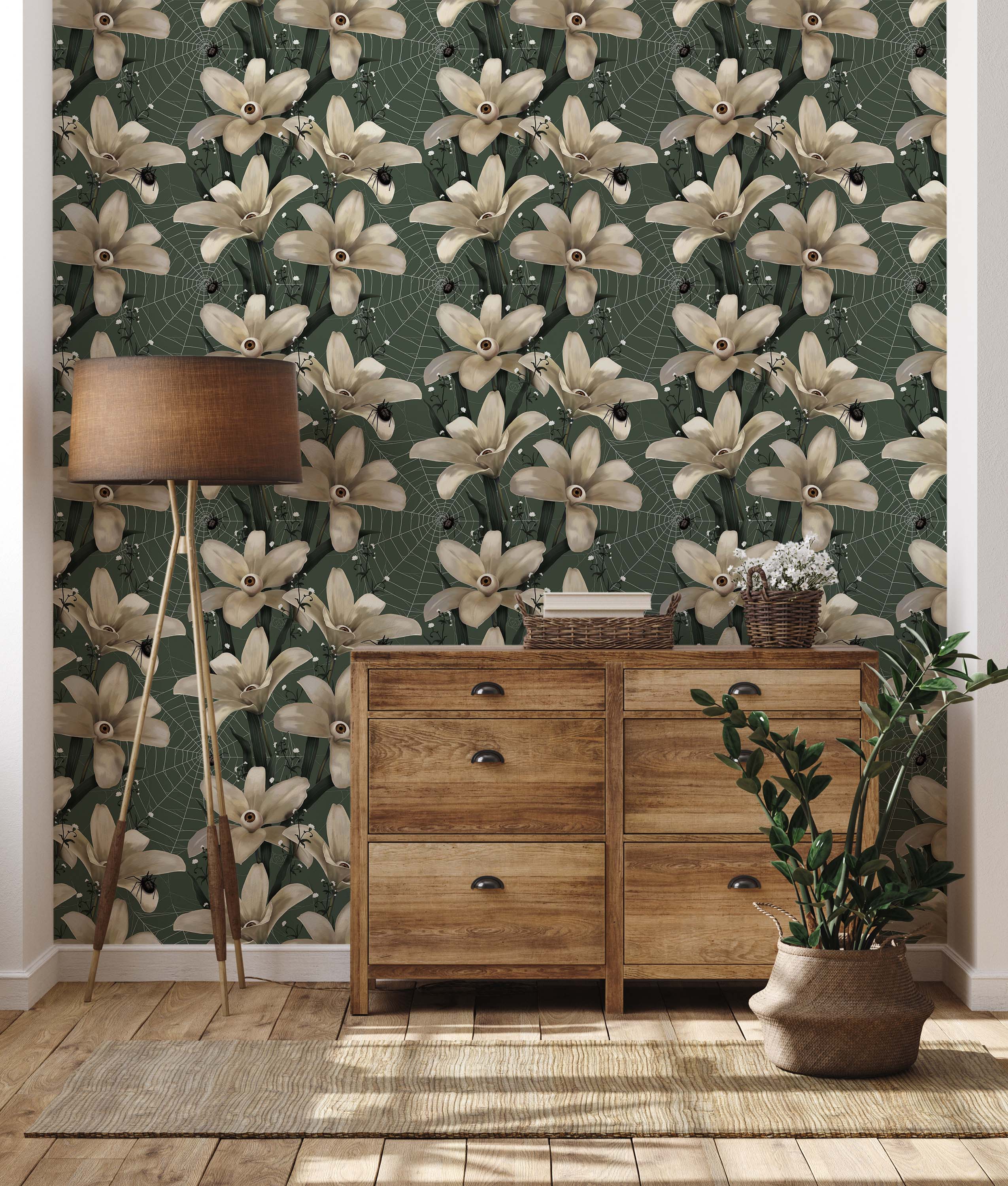 Gothic floral wallpaper with cream-colored flowers with eyeballs, black spiders, and webs on a dark green background.