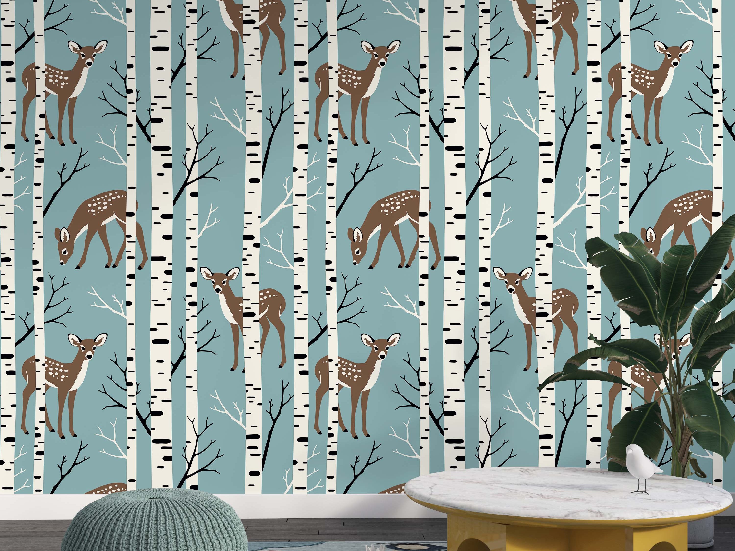 A cute wallpaper pattern featuring brown, spotted fawns and white birch trees against a dusty blue background.