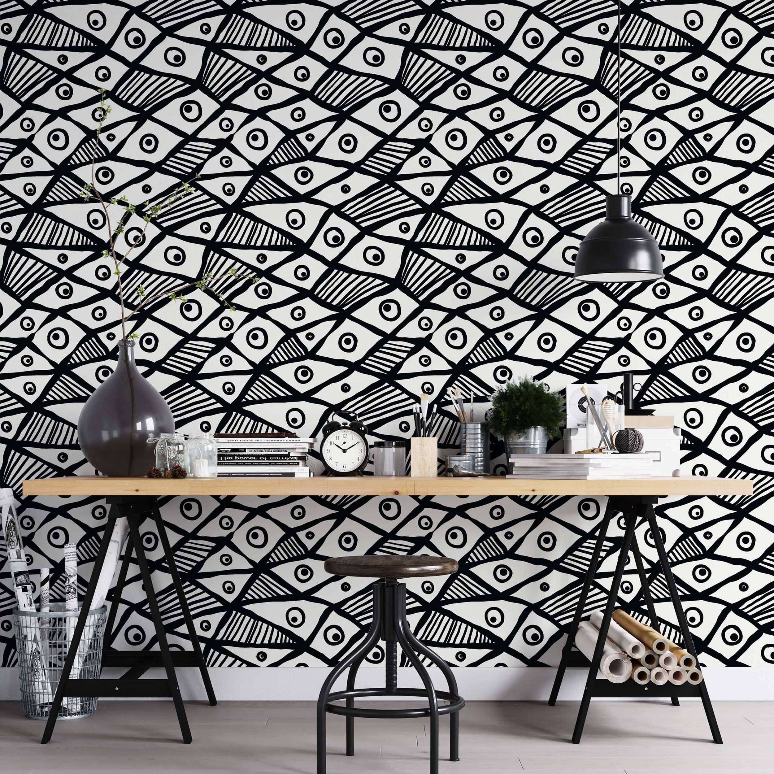 Hand-drawn black and white wallpaper featuring a repeating pattern of abstract fish or eye shapes with bold lines and stripes.