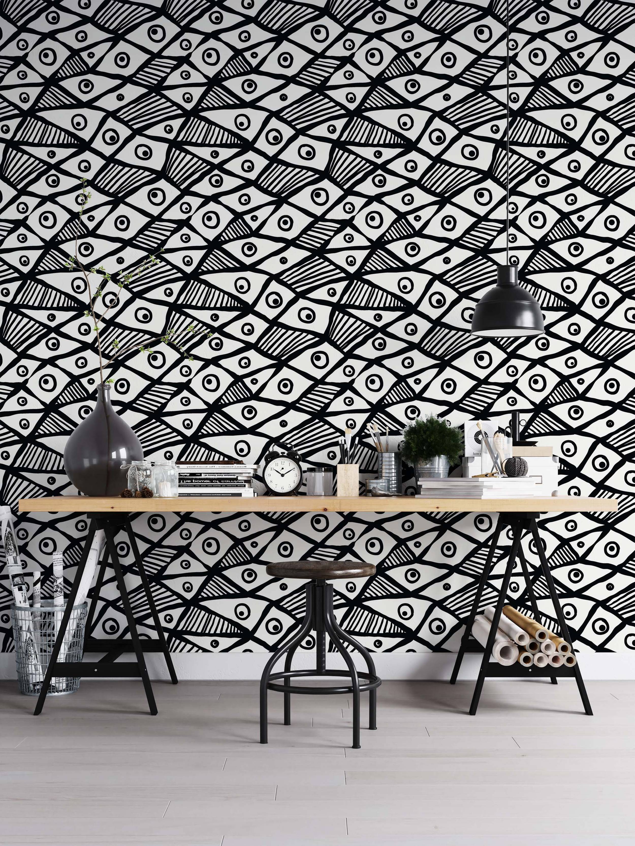 Hand-drawn black and white wallpaper featuring a repeating pattern of abstract fish or eye shapes with bold lines and stripes.
