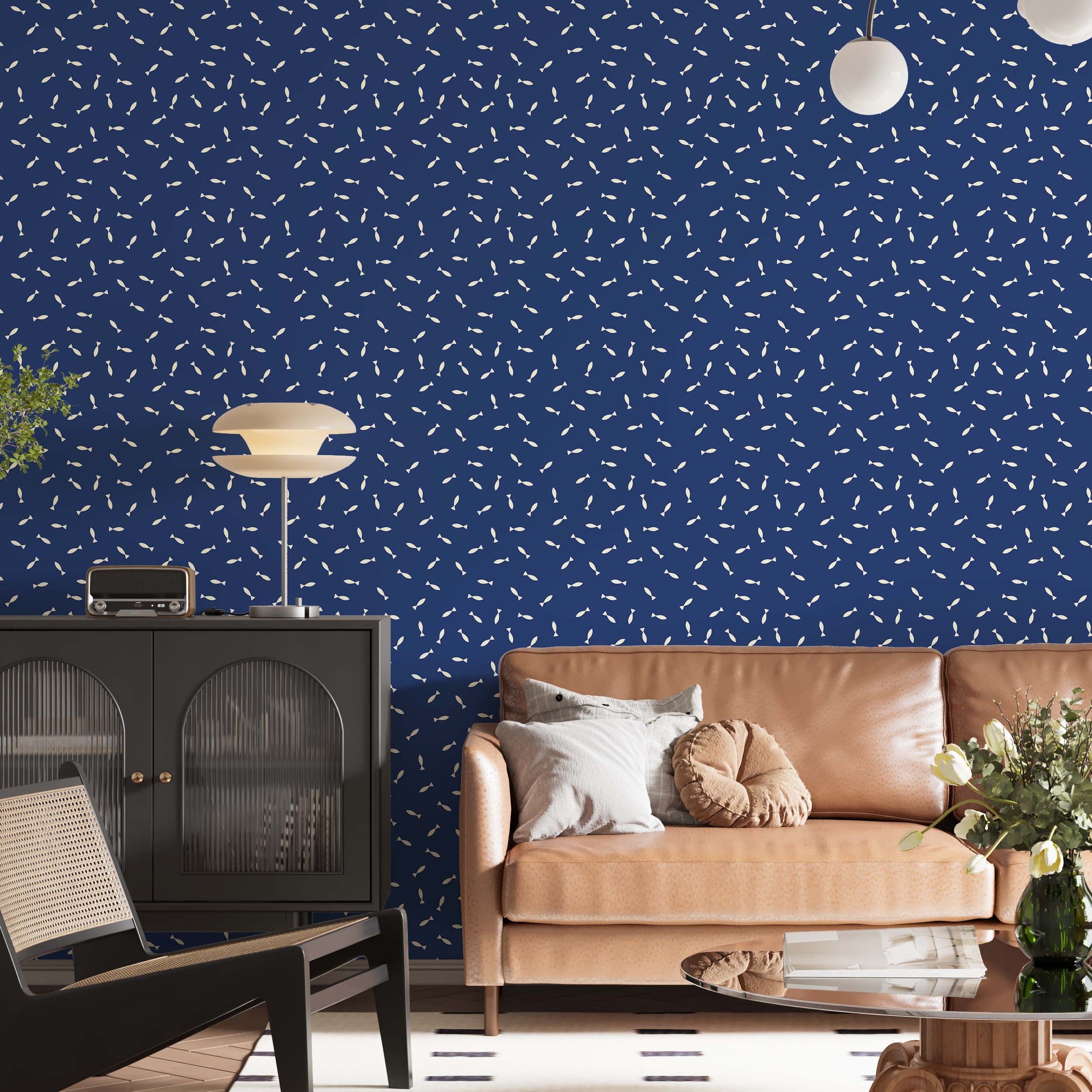 Wallpaper featuring a playful pattern of small, cream-colored fish scattered across a deep blue background.