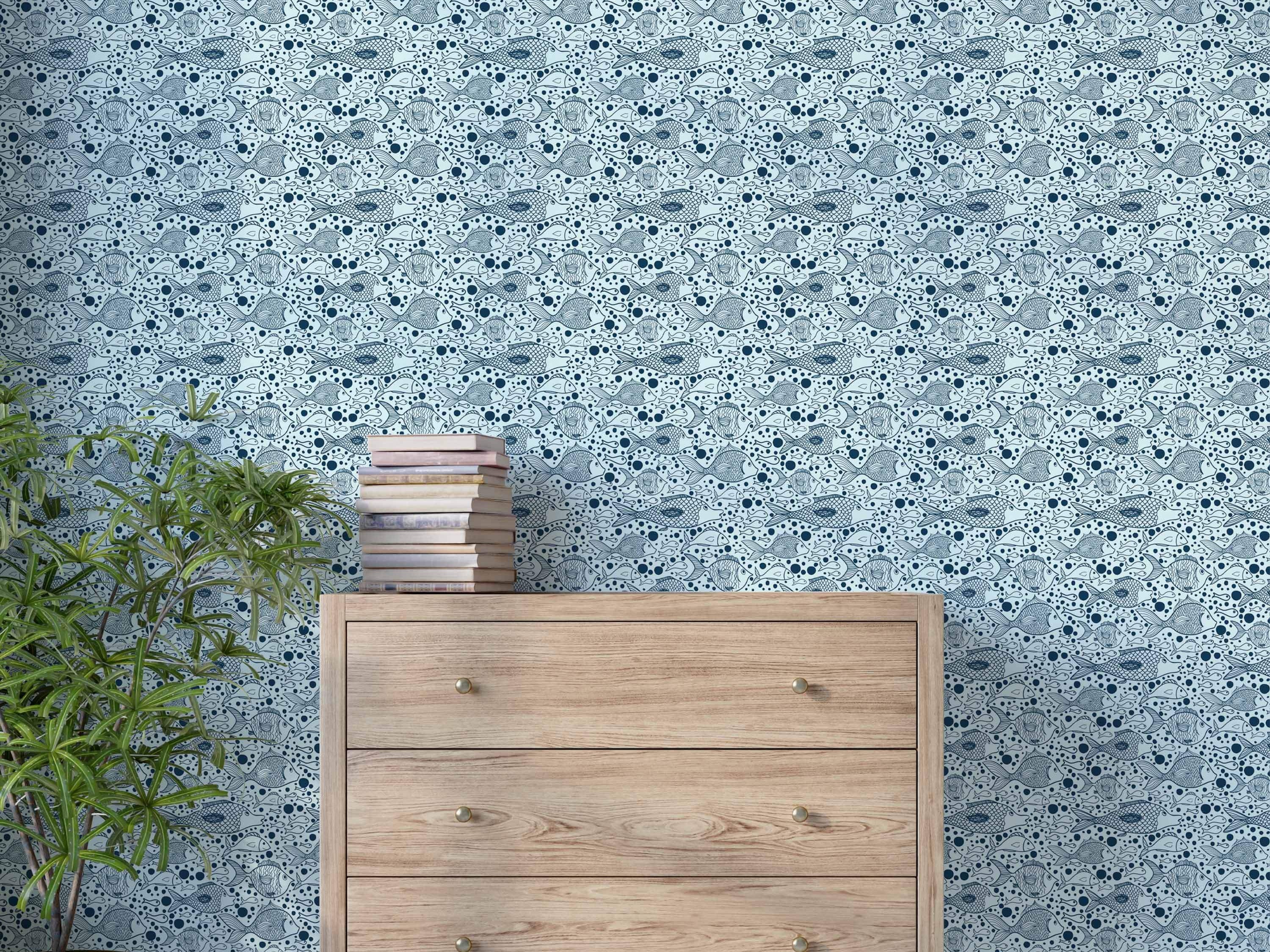 Wallpaper features a pattern of blue illustrated fish and dots swimming across a pale blue background.