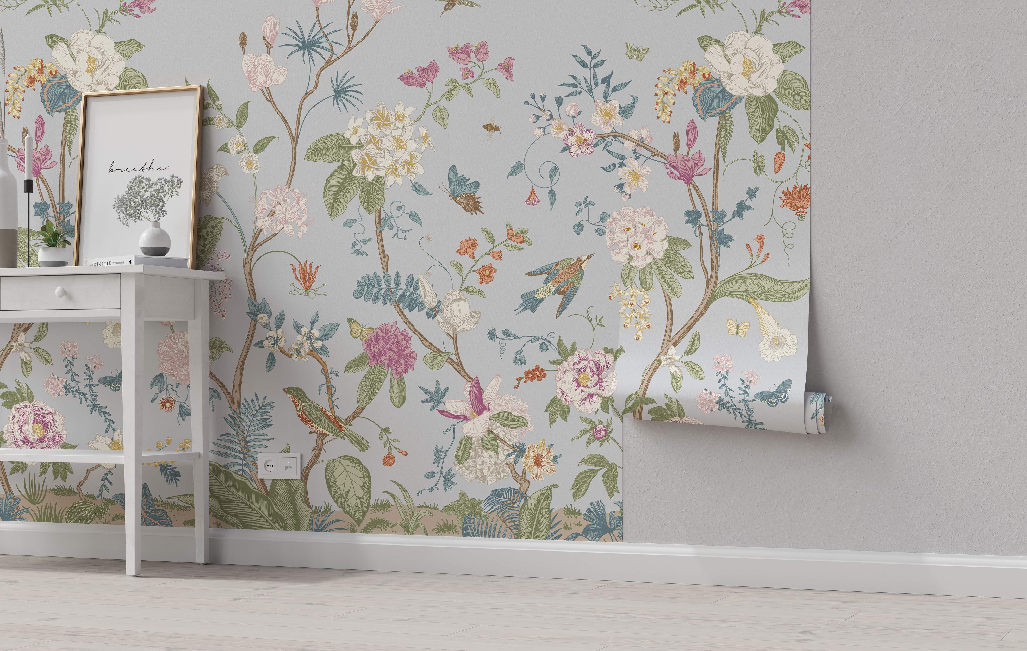 Chinoiserie-style mural featuring pastel flowers, birds, and butterflies climbing vines on a soft grey background.