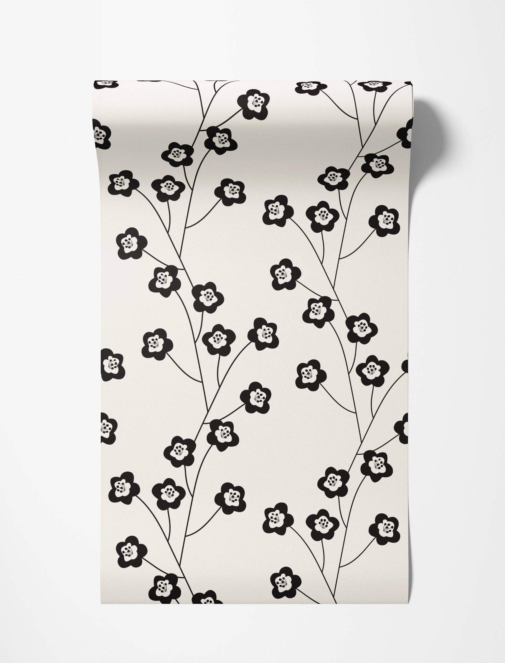 Wallpaper with a repeating pattern of stylized black flowers on delicate black stems against a cream background.