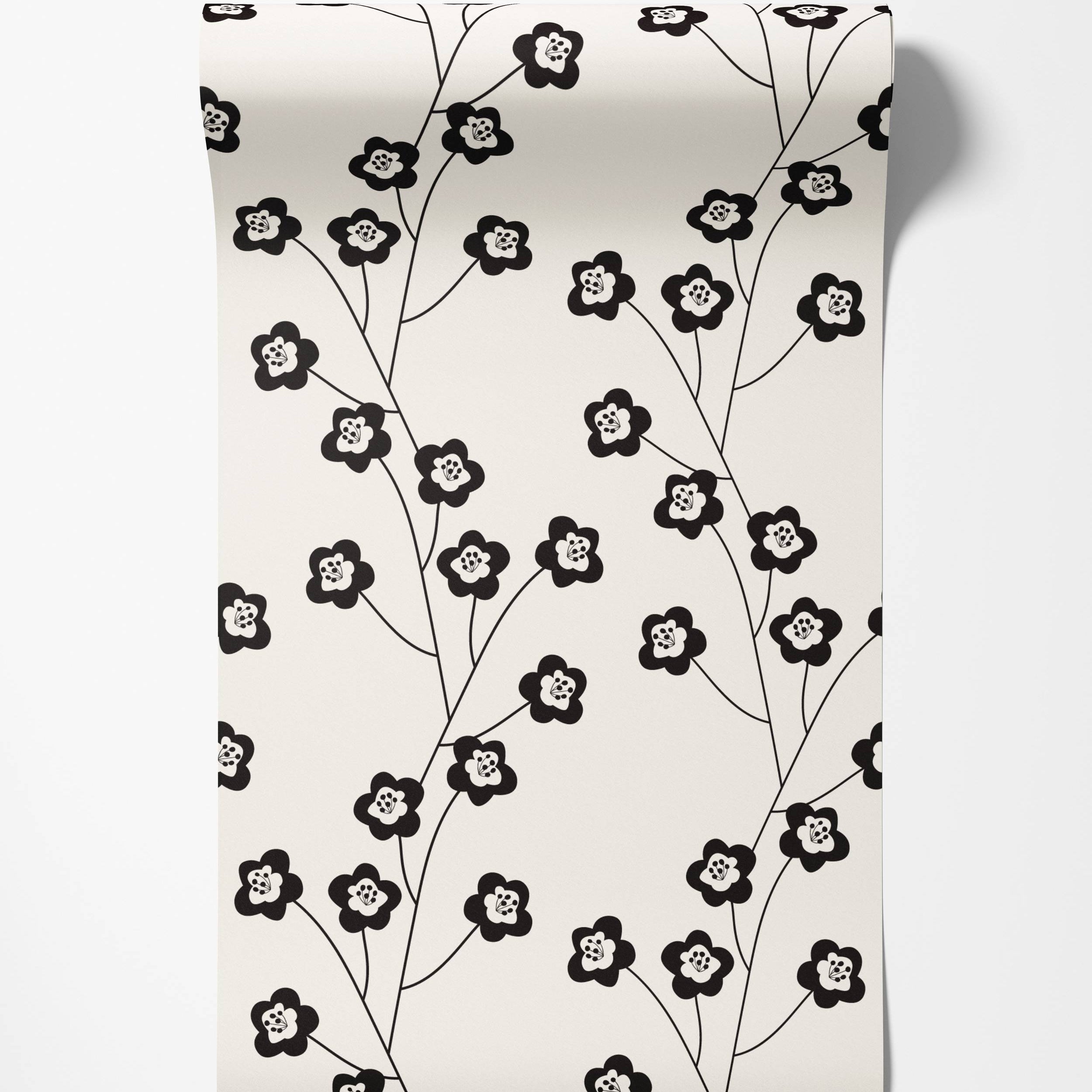 Wallpaper with a repeating pattern of stylized black flowers on delicate black stems against a cream background.