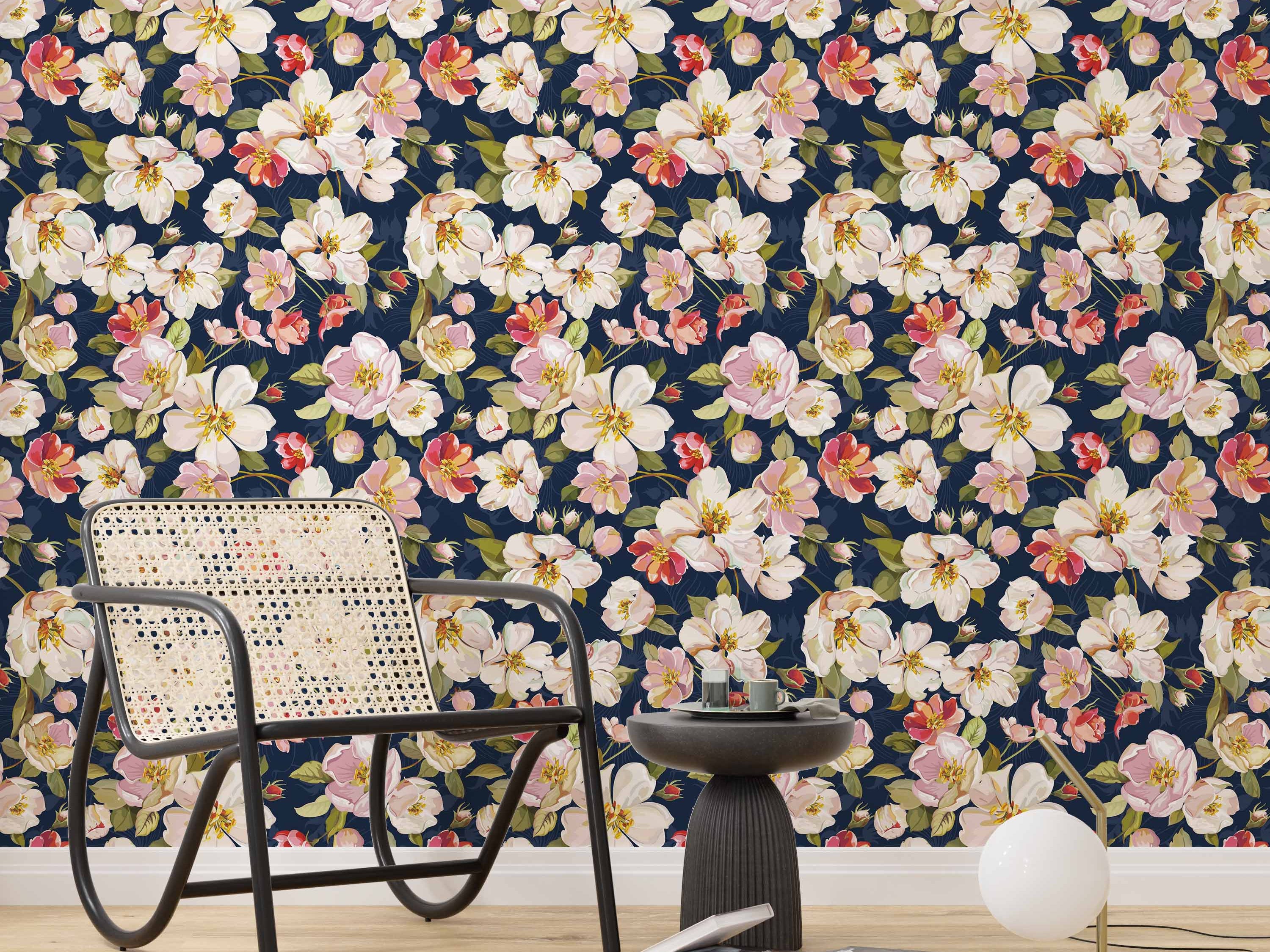 Watercolor floral wallpaper with white, pink, and red blossoms and green leaves scattered across a dark navy blue background.