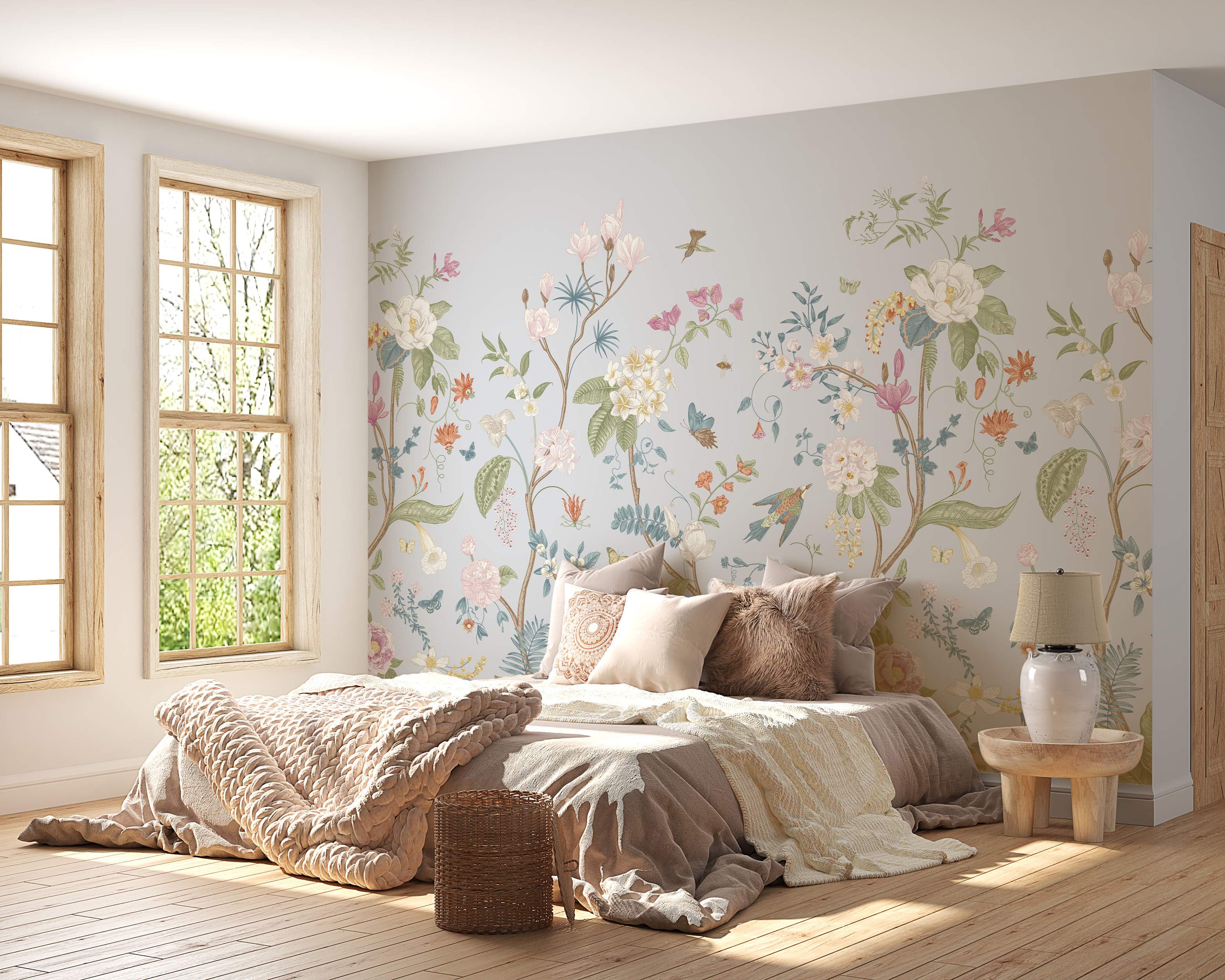 Illustrative floral mural featuring pastel flowers, vines, birds, and butterflies on a light gray-blue background.