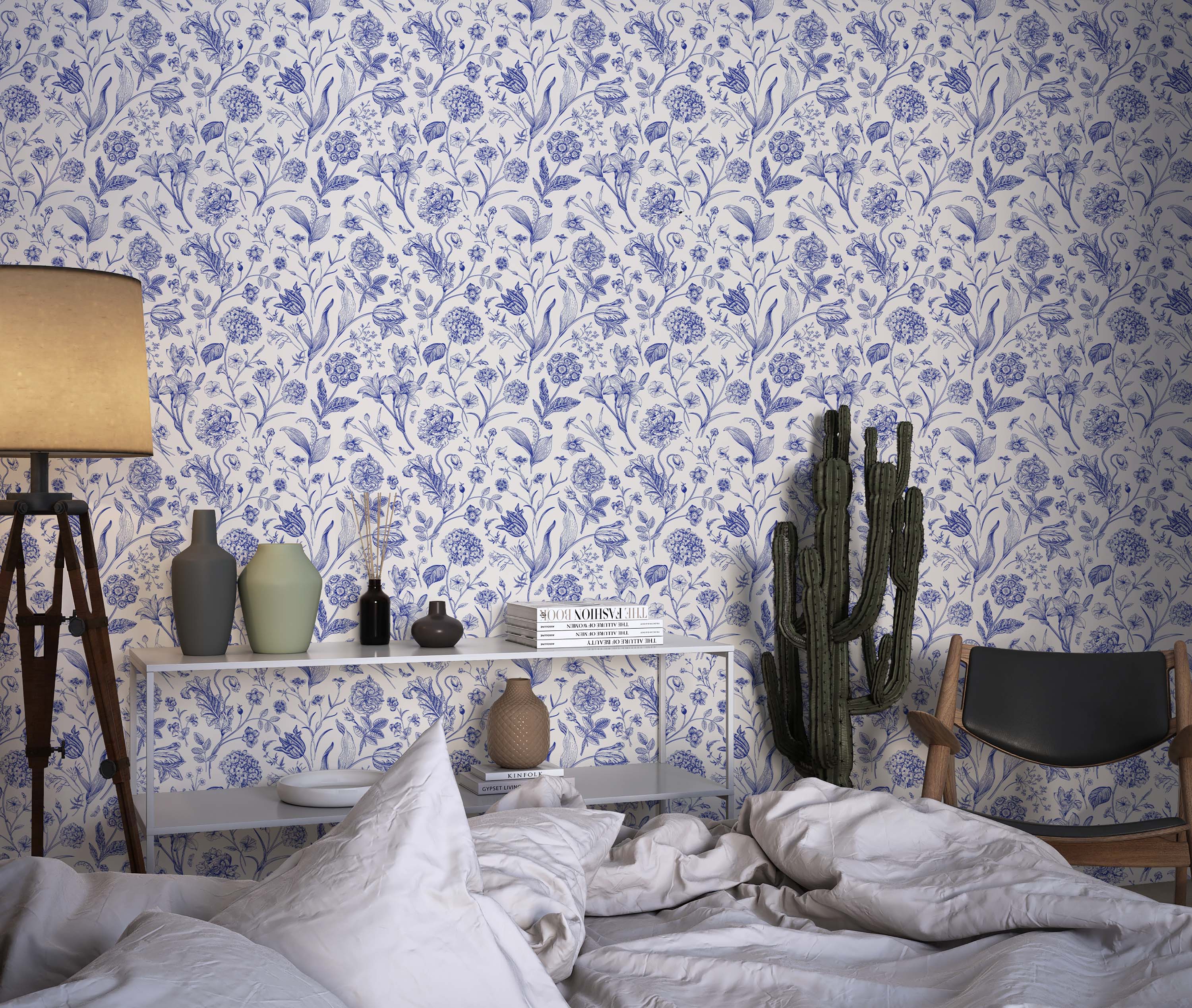 A botanical wallpaper with detailed, blue line drawings of various flowers and leaves scattered across an off-white background.