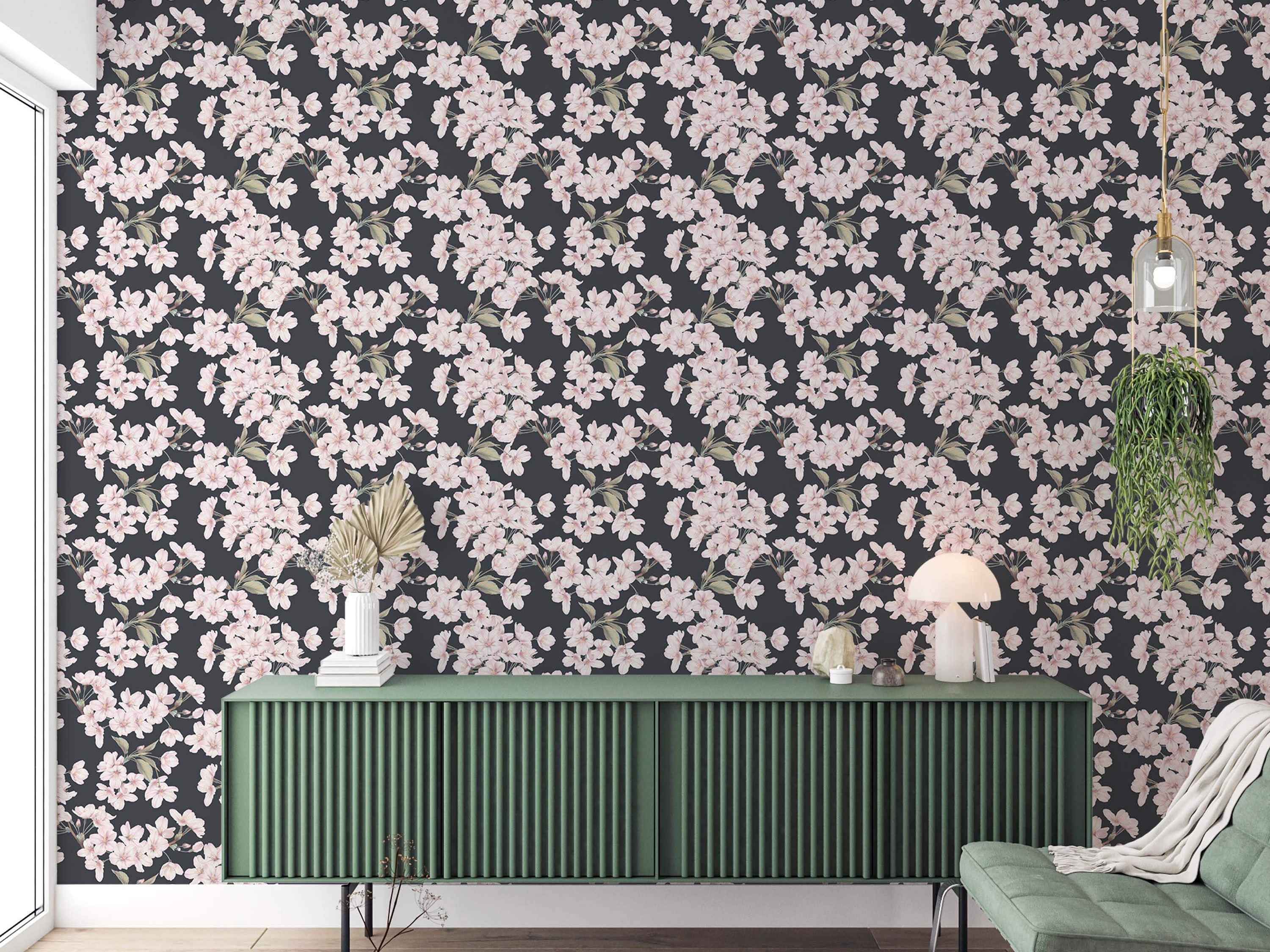 Wallpaper featuring clusters of light pink cherry blossoms with green leaves scattered across a dark gray background.