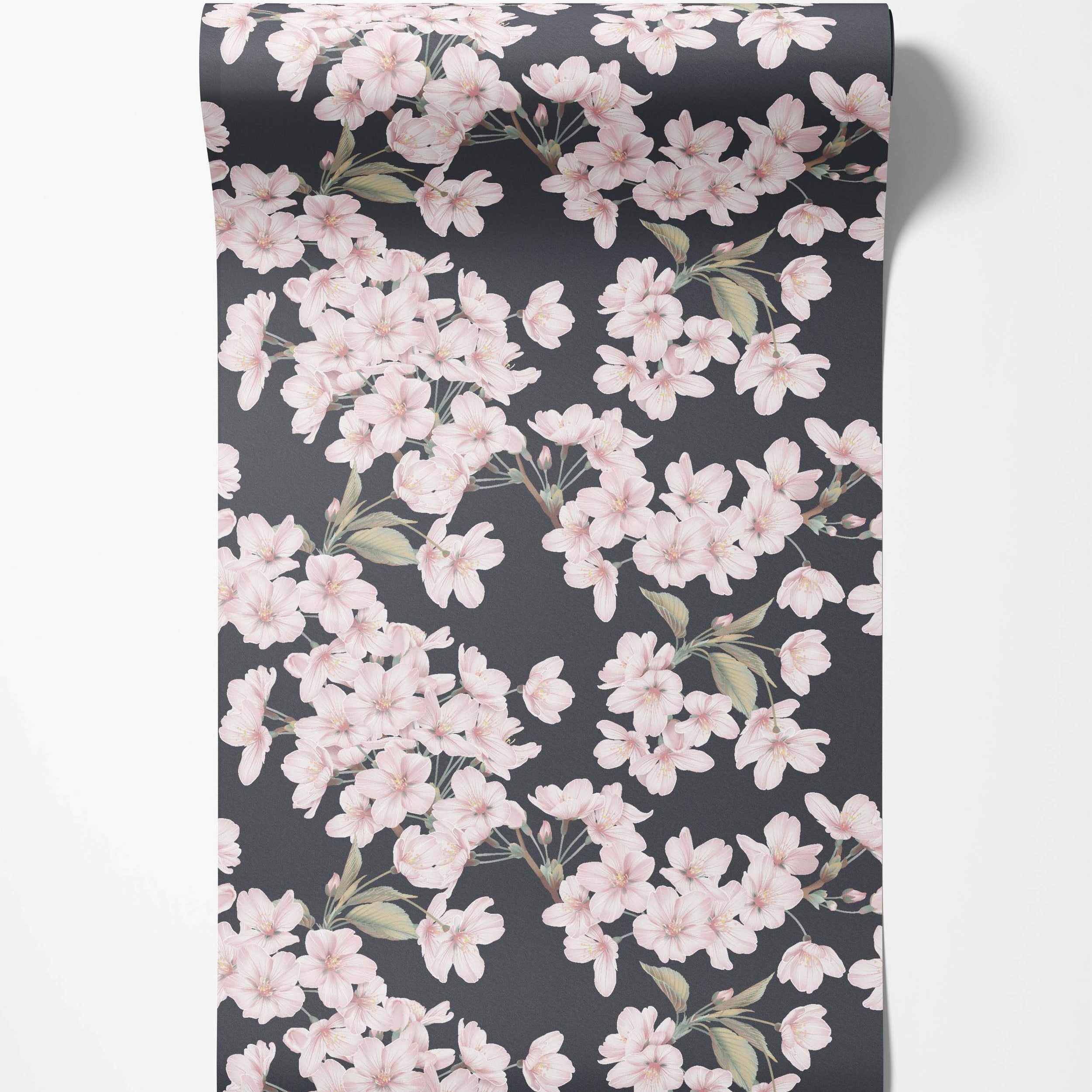 Wallpaper featuring delicate pink cherry blossoms and green leaves scattered across a dark gray background.