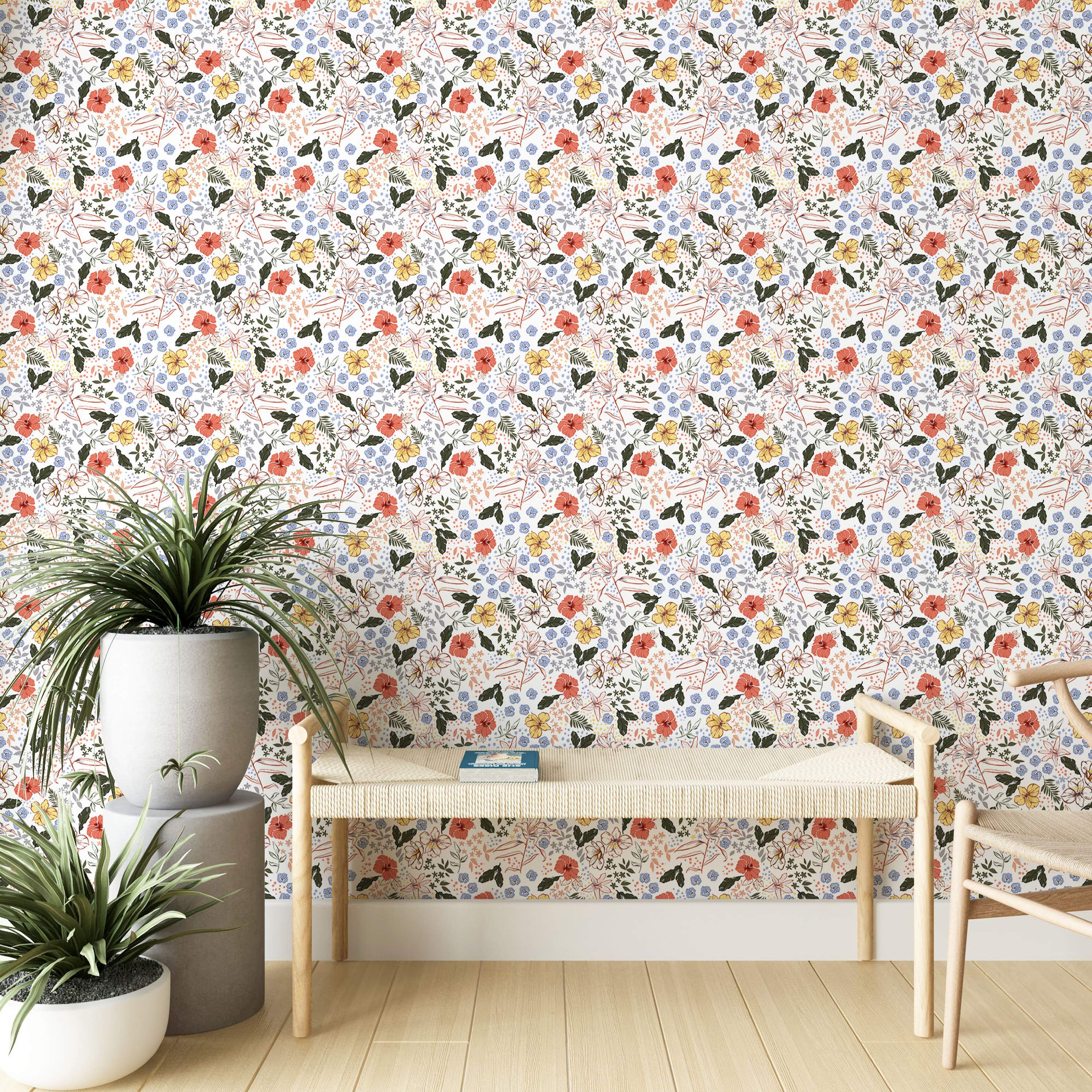 Wallpaper with a dense floral pattern featuring coral, yellow, and outlined flowers, small blue blooms, and green leaves on white.