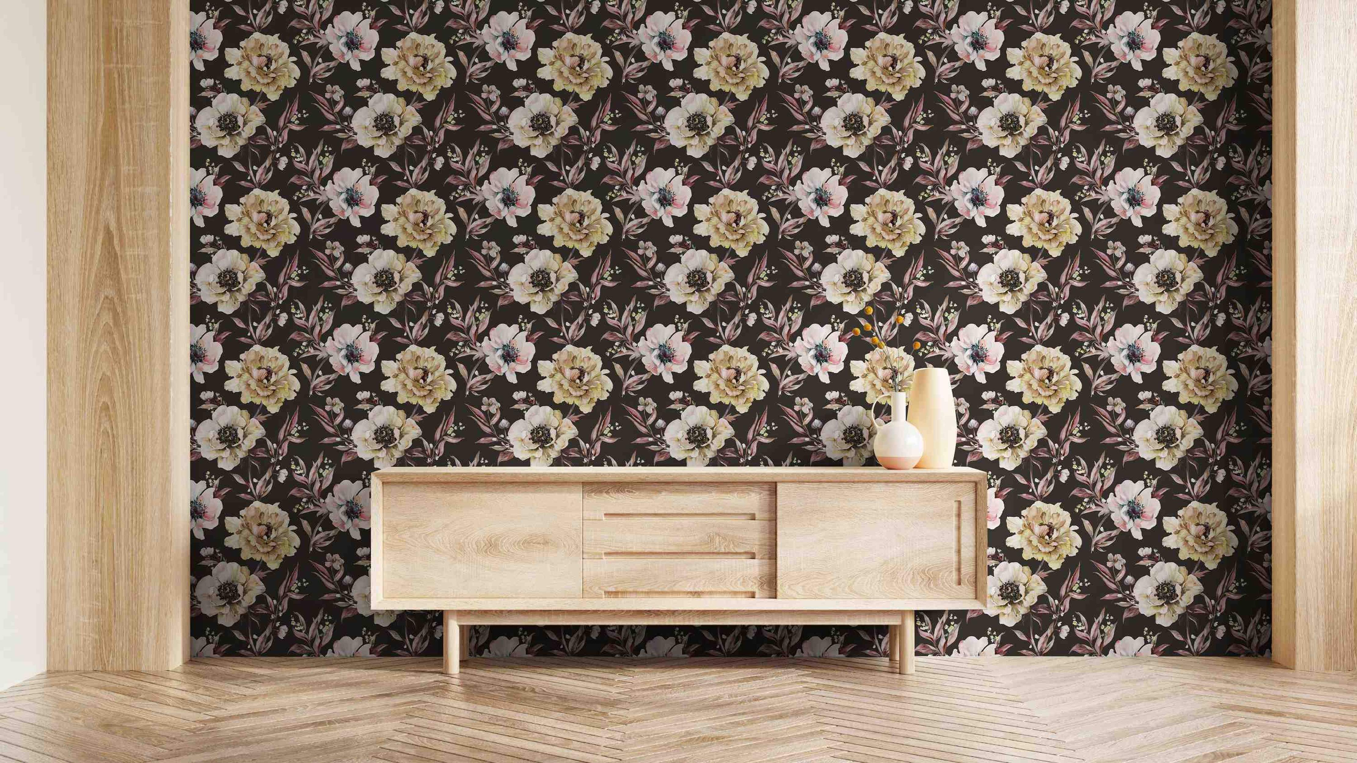 Watercolor floral wallpaper with cream, yellow, and pink peonies and foliage on a dark brown, almost black, background.