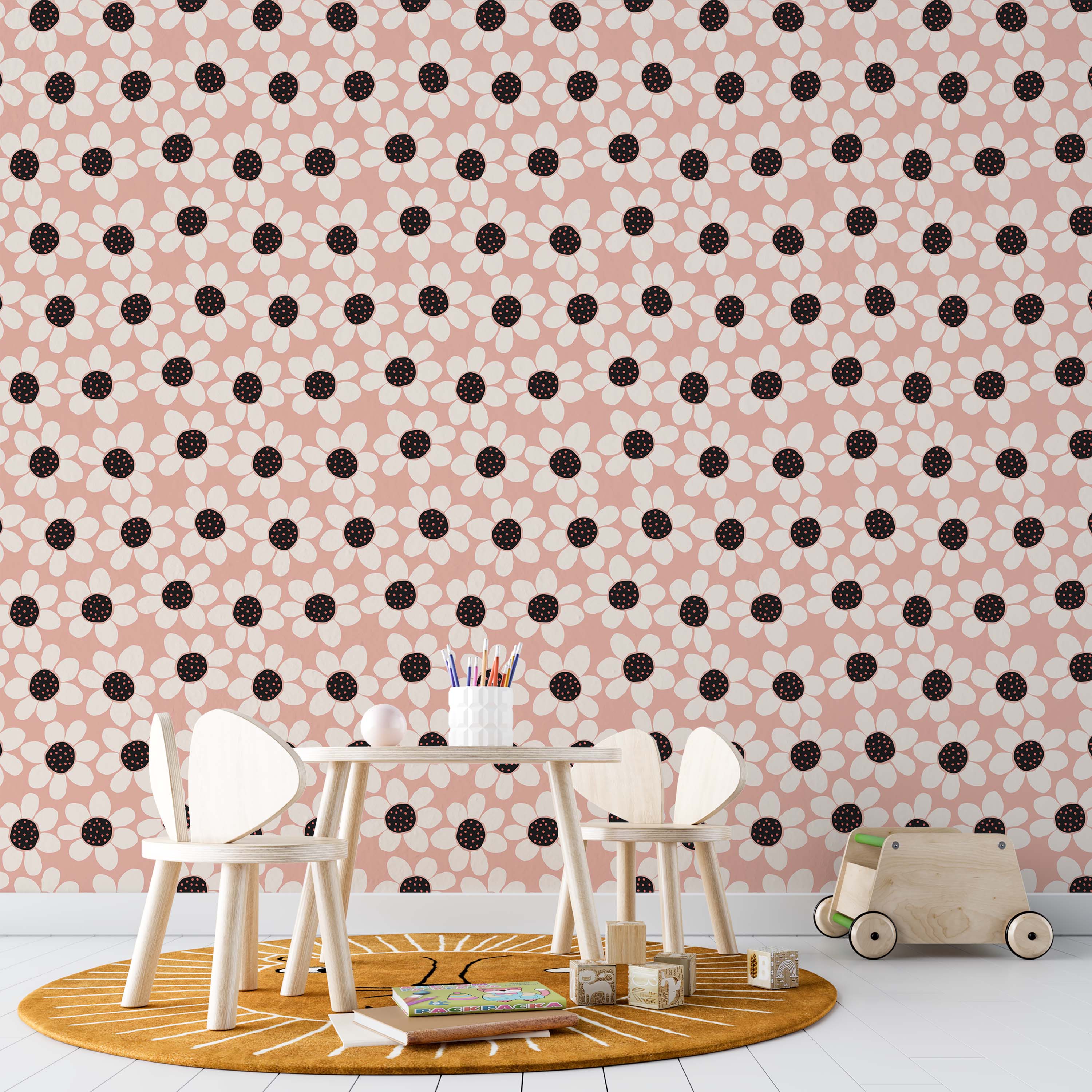 Wallpaper with a repeating floral design: cream daisies with black, pink-dotted centers on a dusty pink ground.