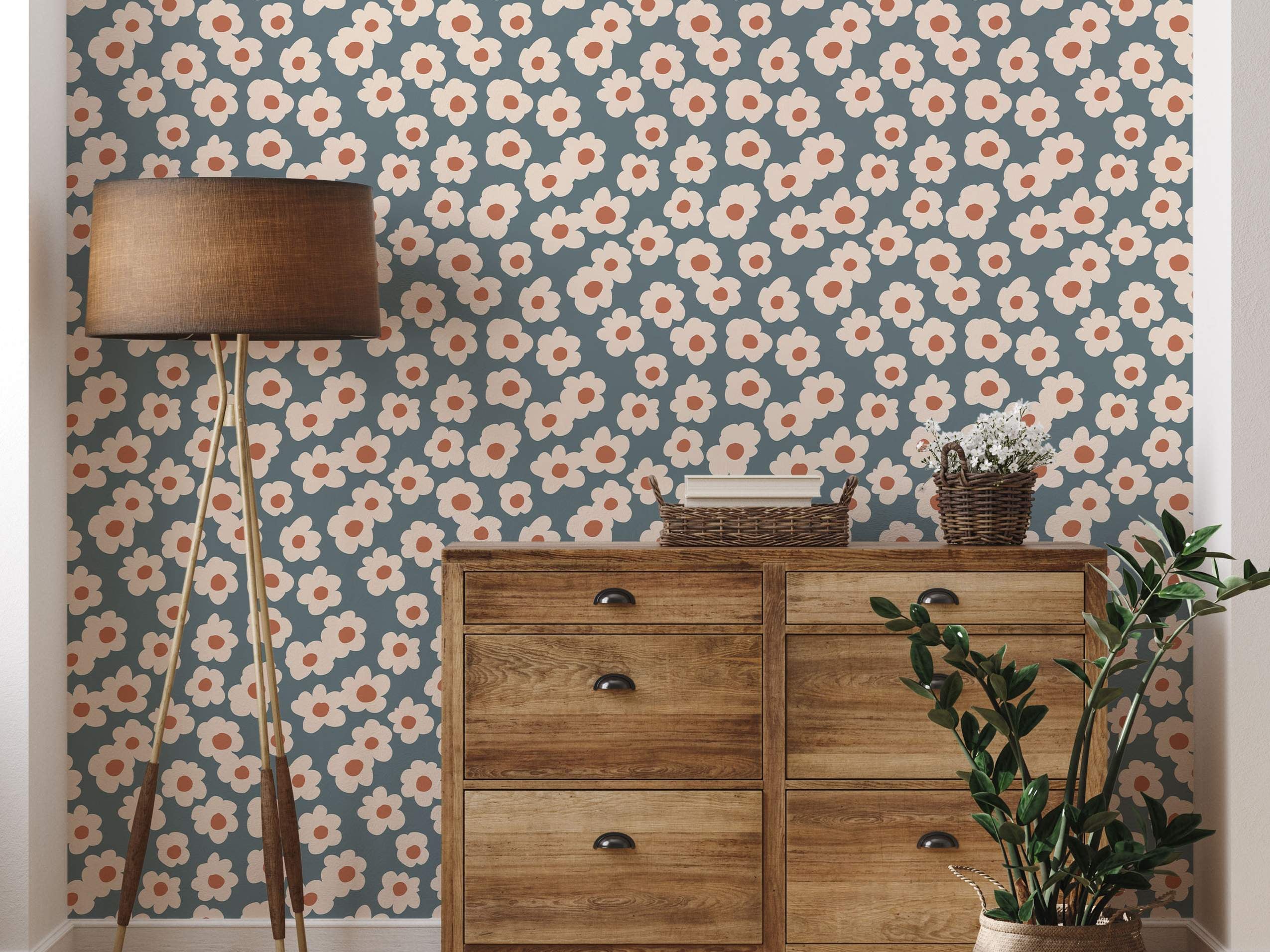 Wallpaper featuring a repeating pattern of stylized cream daisies with orange centers on a muted teal background.