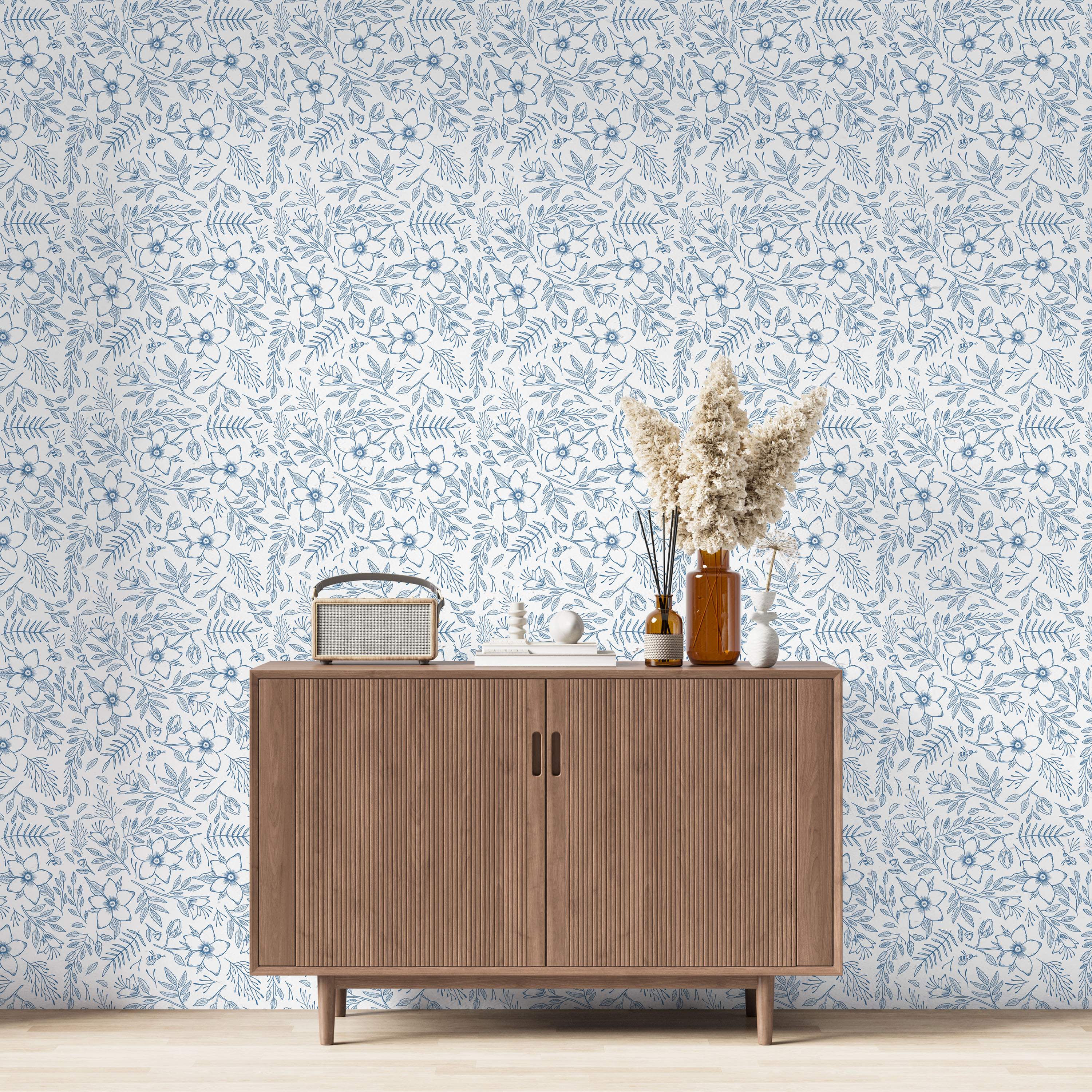 Wallpaper featuring a blue line-drawn pattern of flowers, leaves, and small bees scattered across a white background.