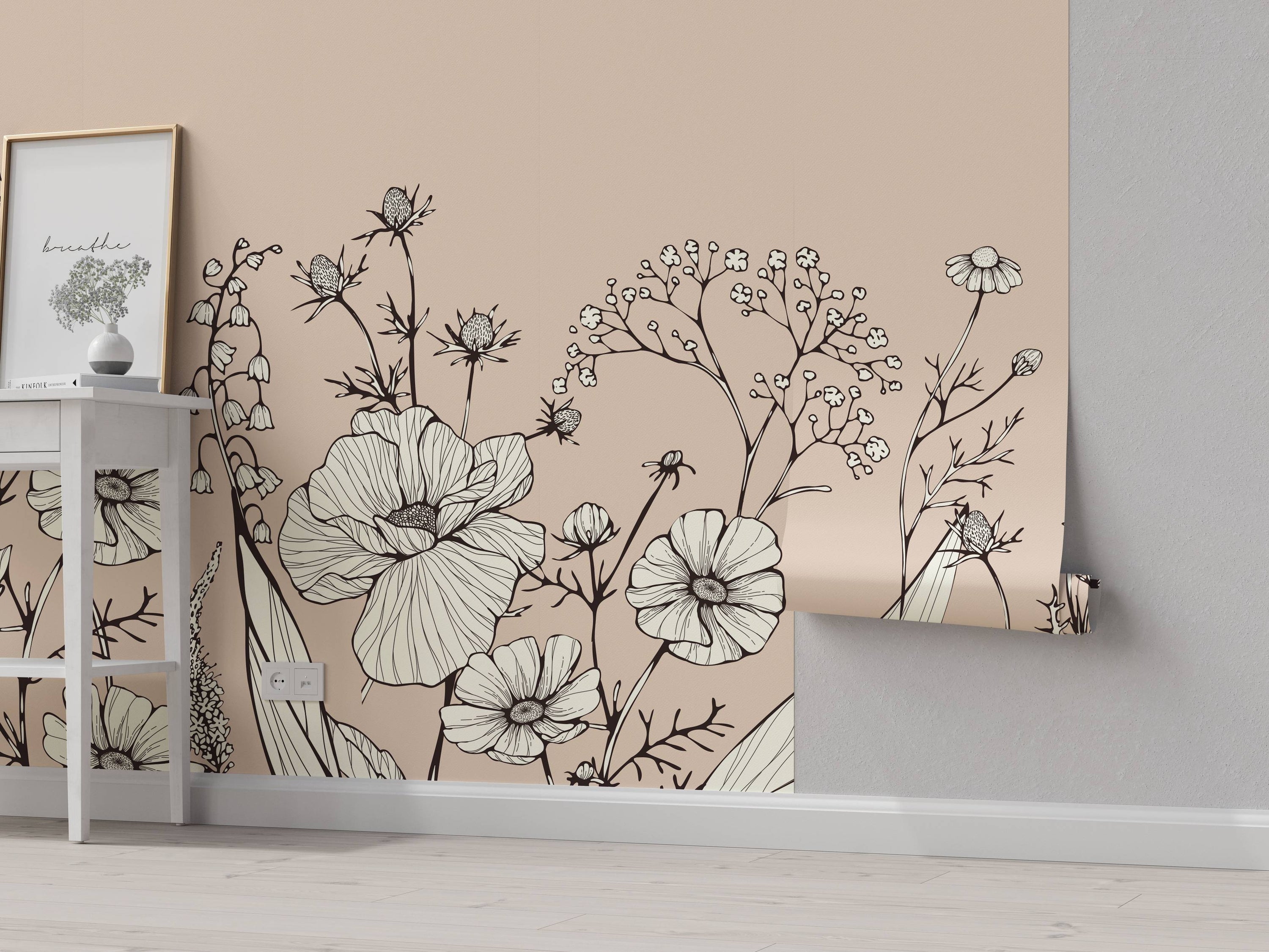 Floral line art wallpaper with black outlined flowers, cream petal fills, on a pale beige background.