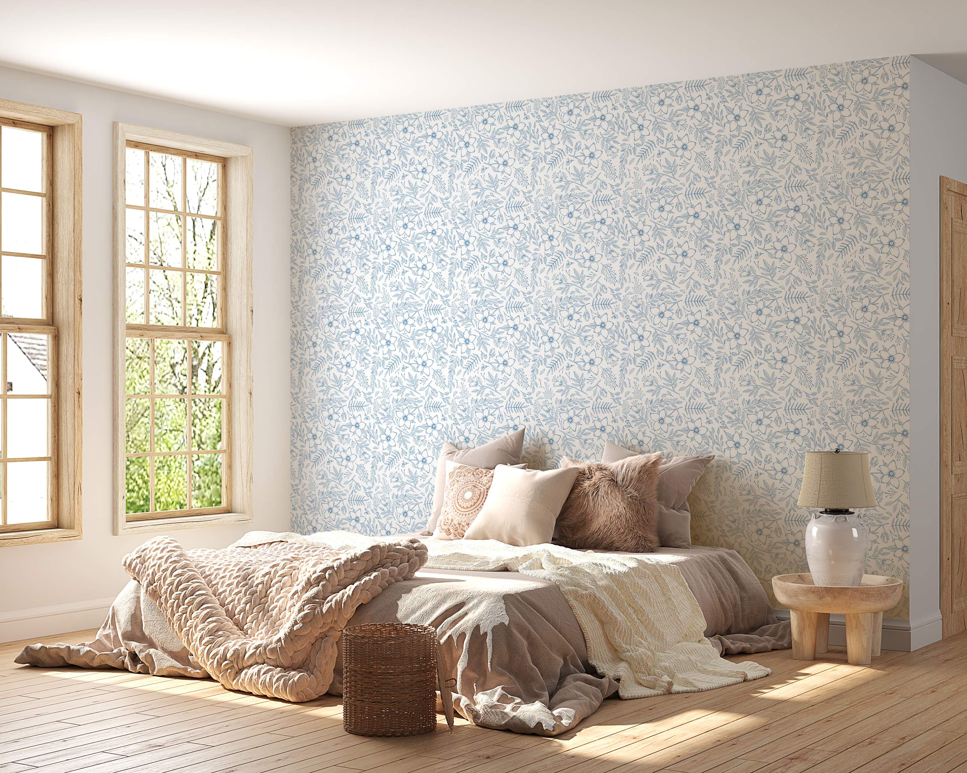 Blue sketched floral wallpaper with hand-drawn flowers, leaves, and ferns scattered across an off-white background.