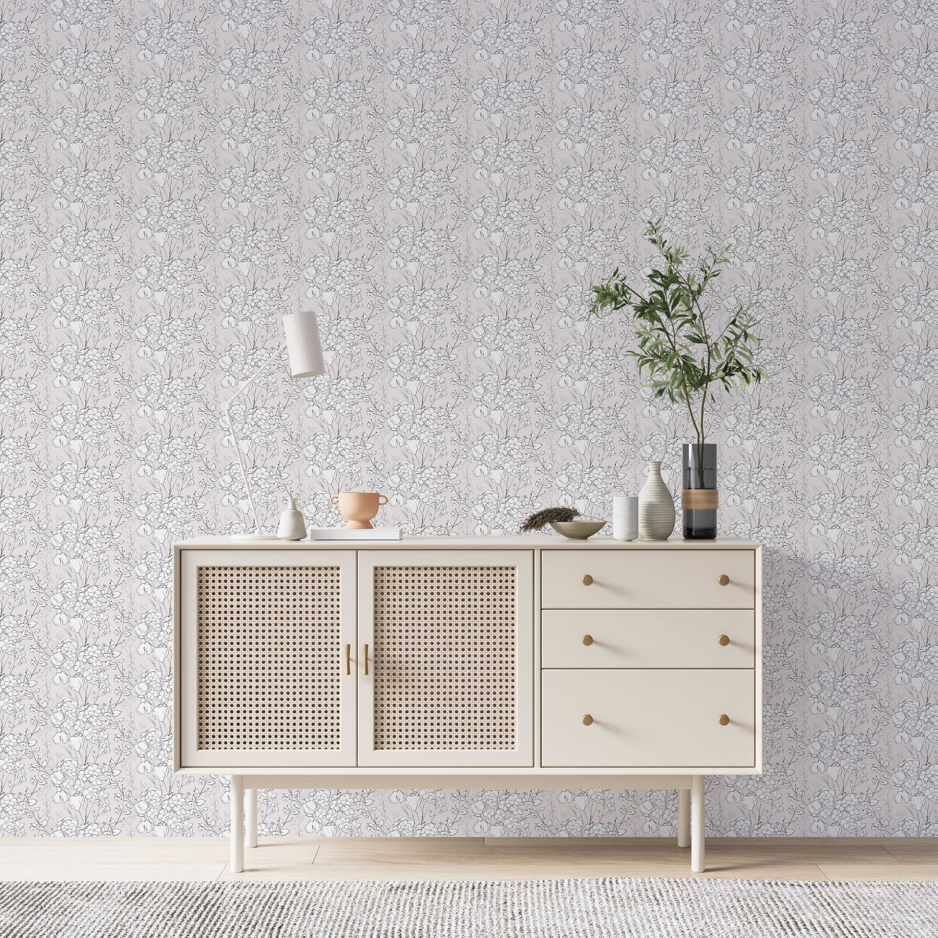 Light grey wallpaper with a repeating pattern of black floral line art, featuring flower clusters and leaves with white accents.