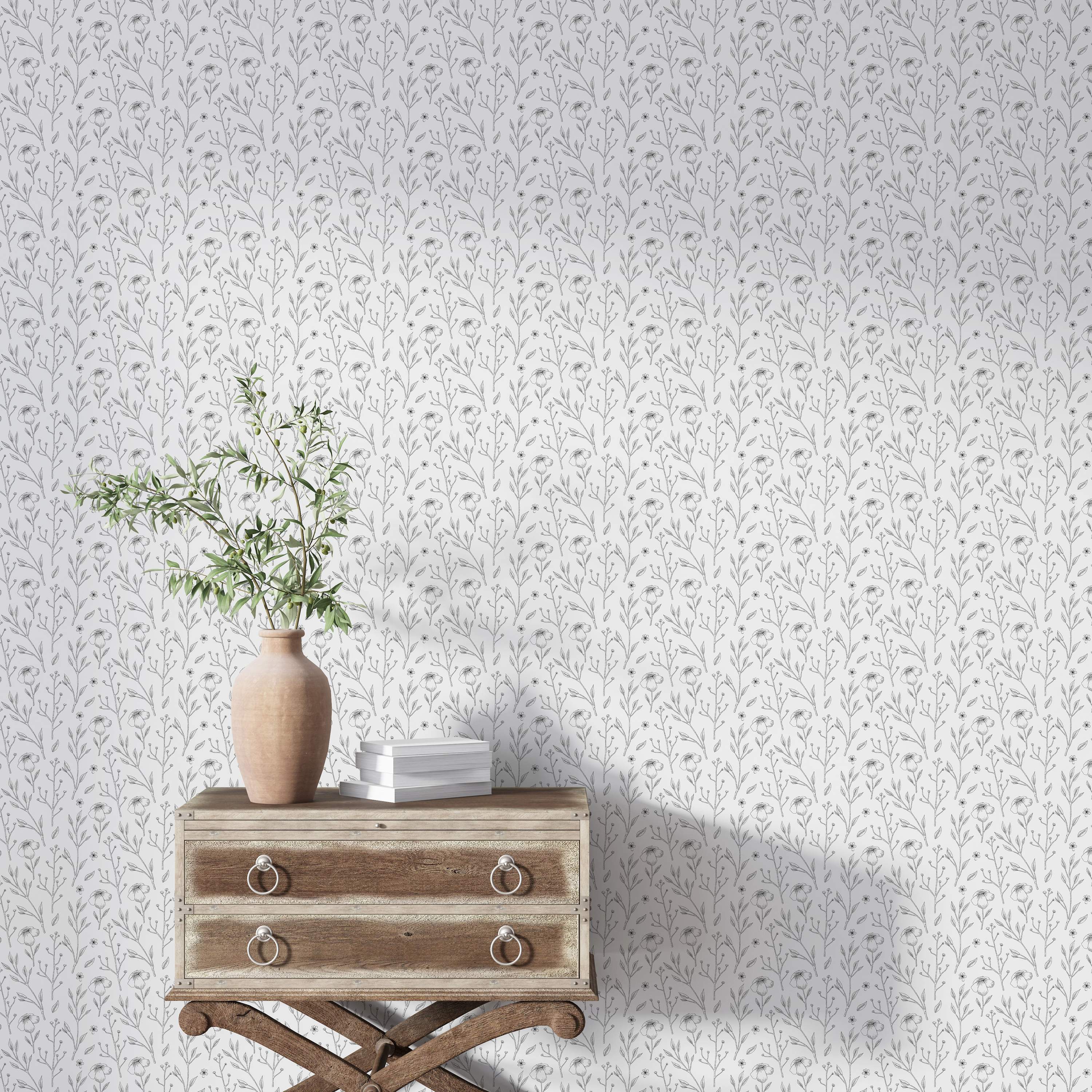 Wallpaper featuring a delicate gray line drawing of floral stems, leaves, and blossoms on a white background.