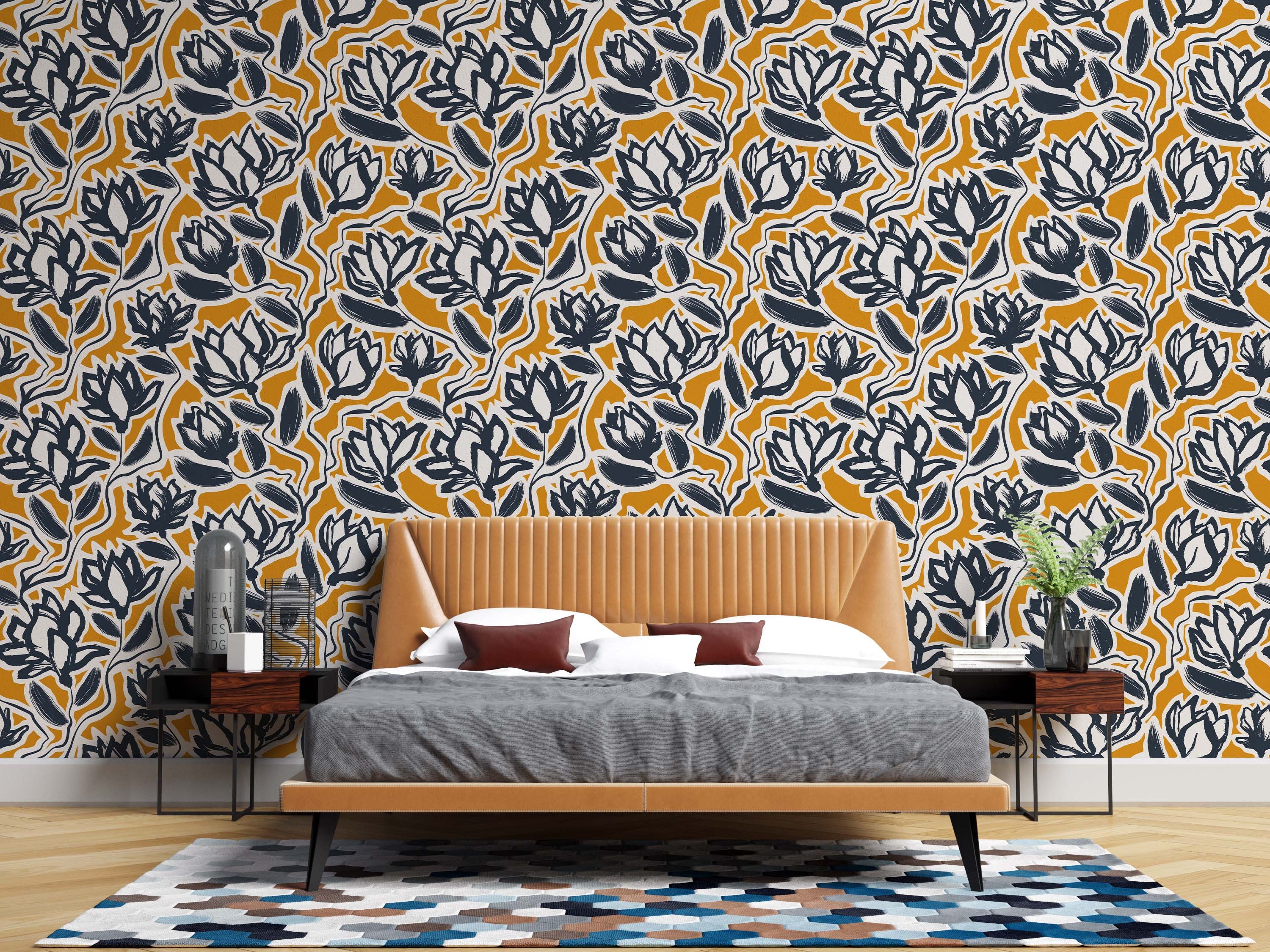 A modern floral wallpaper with a bold, painterly pattern of dark navy and off-white flowers on a rich mustard yellow field.