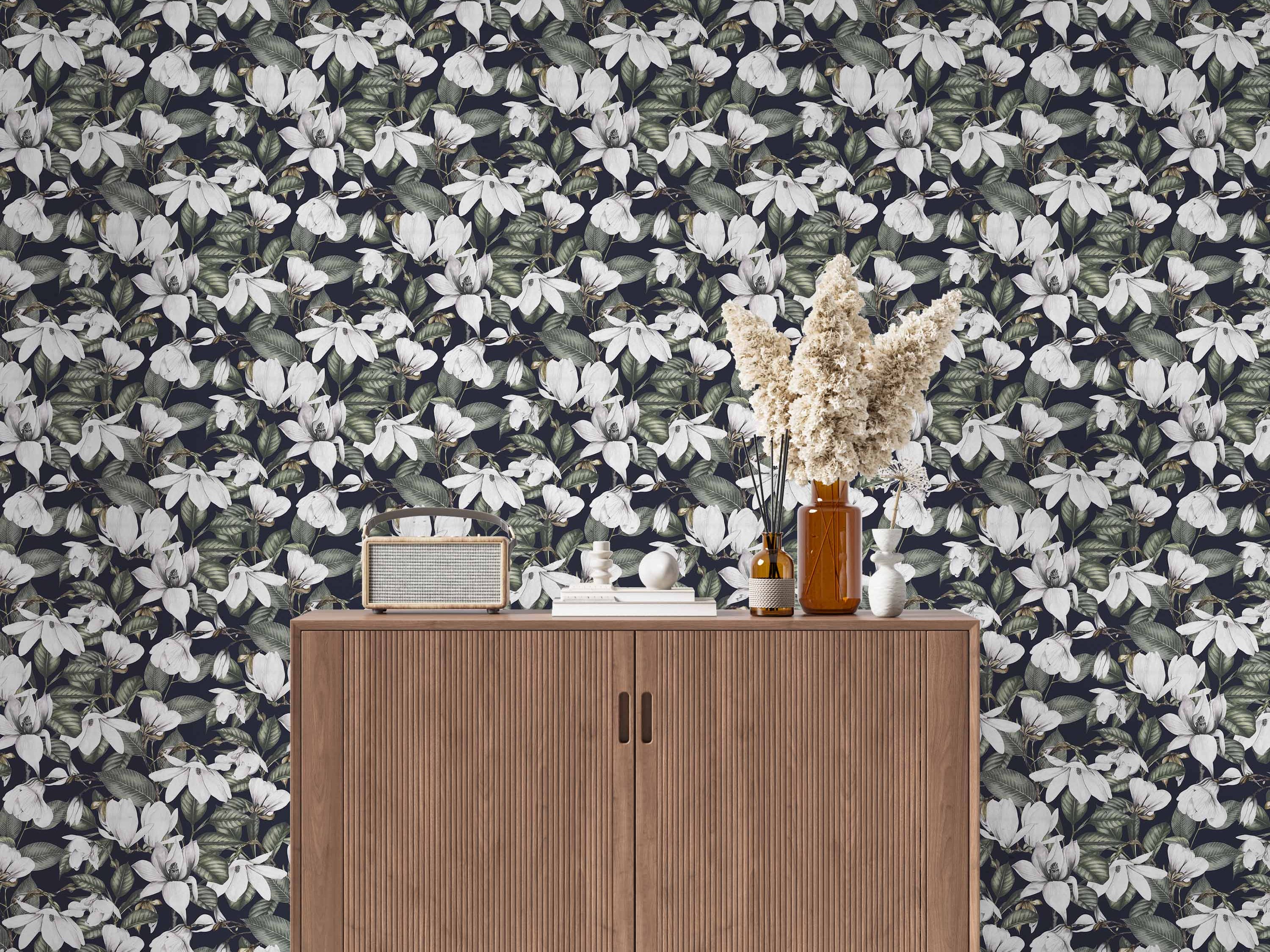 Wallpaper featuring a dense pattern of large white magnolia blooms and green foliage against a dark blue-black background.