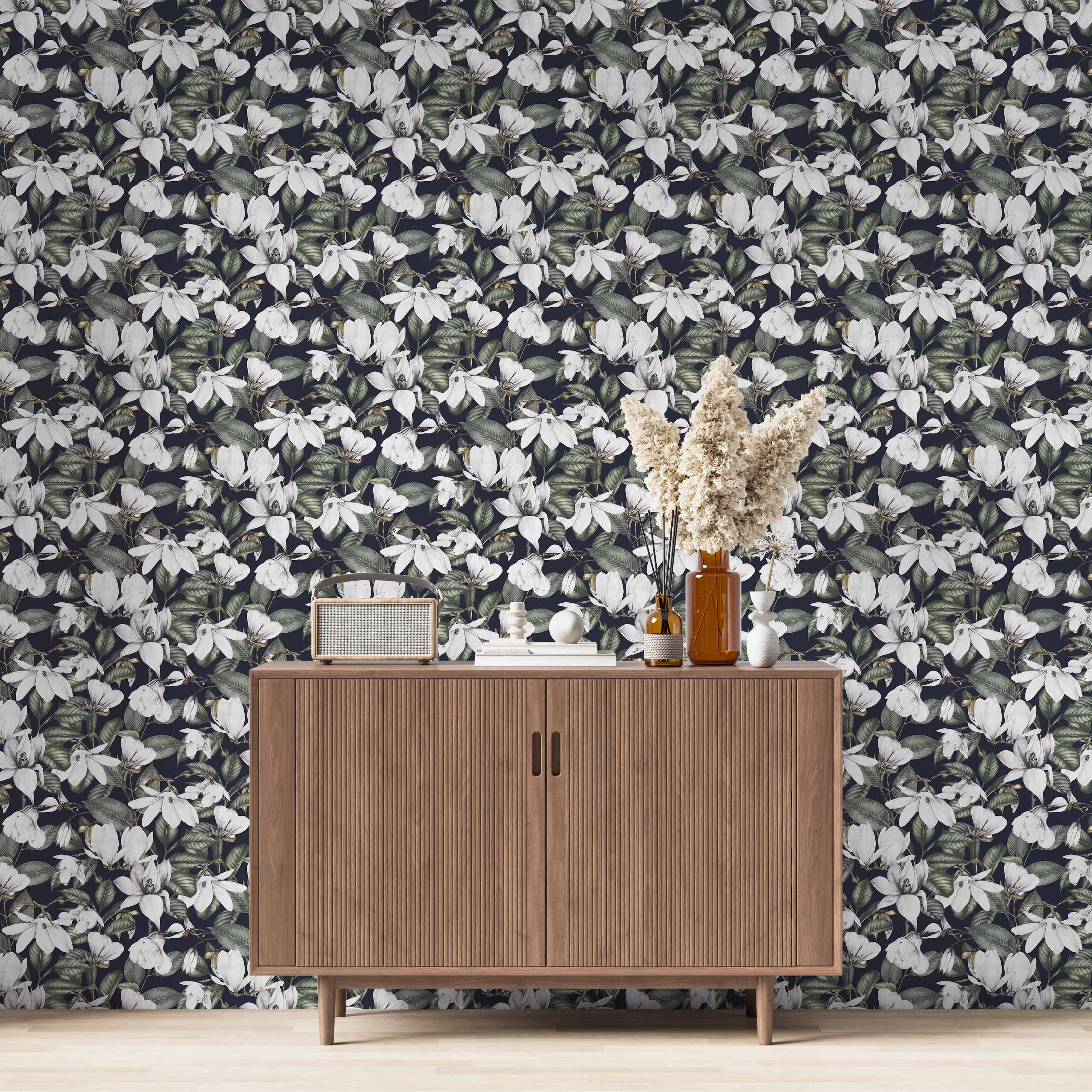 Wallpaper featuring a dense pattern of large white magnolia blooms and green foliage against a dark blue-black background.