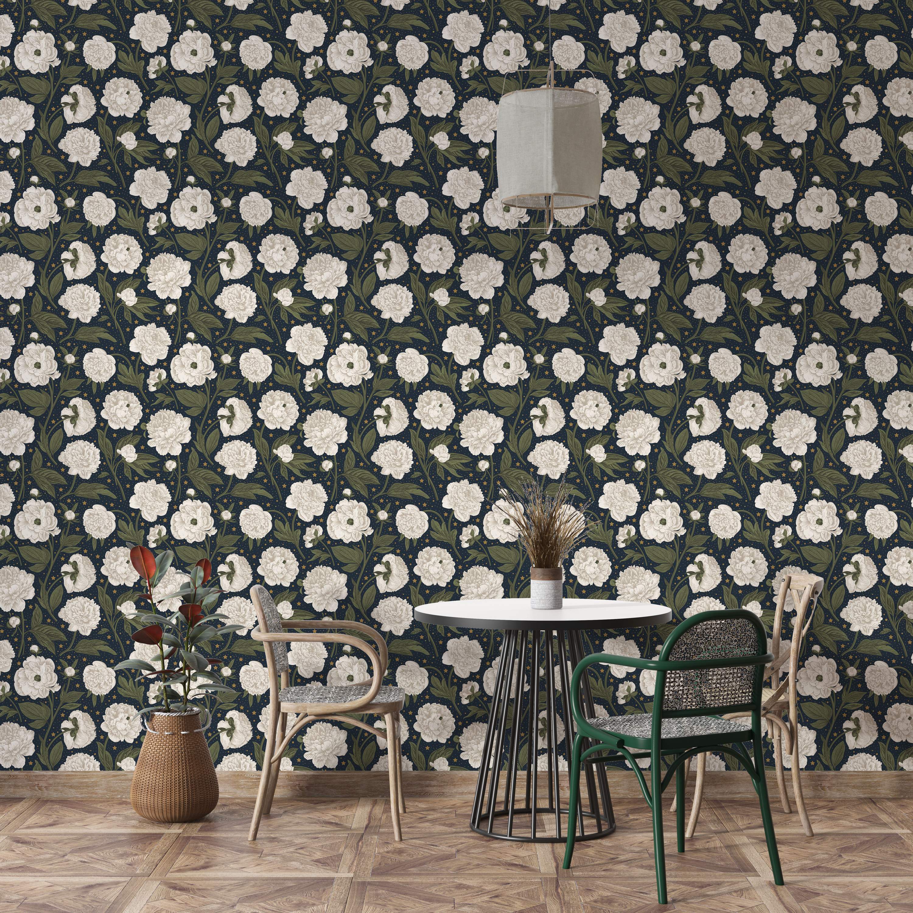 Wallpaper featuring large white peonies and green leaves scattered with tiny yellow stars on a dark navy blue background.