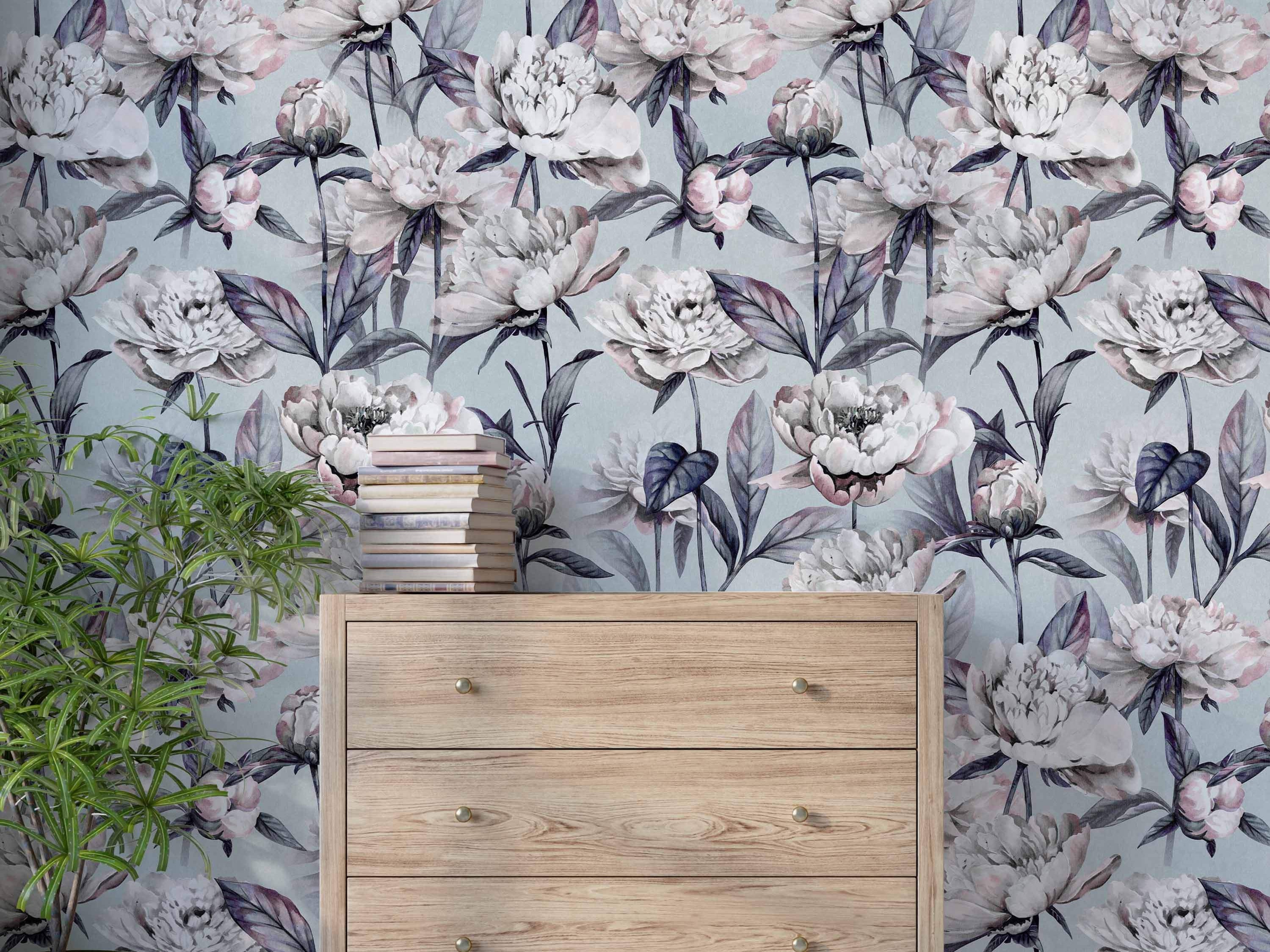 Wallpaper with a repeating pattern of large, painterly white and blush peony flowers with dark purple leaves on a pale blue-grey background.