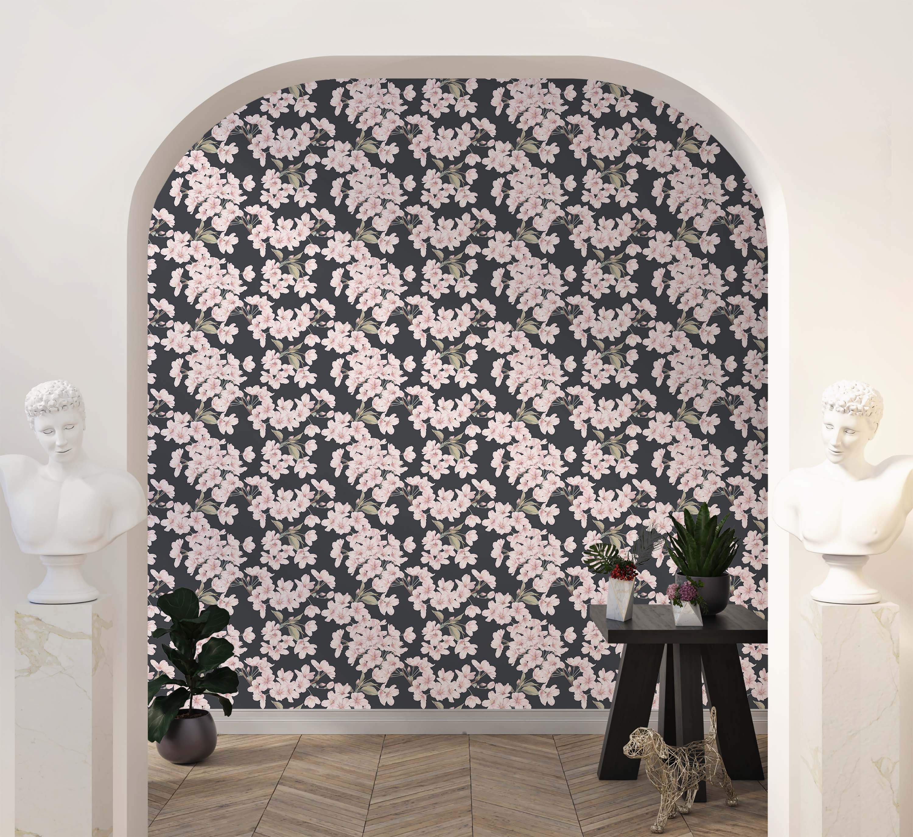 Wallpaper with clusters of soft pink cherry blossoms and subtle green leaves arranged on a dark charcoal background.