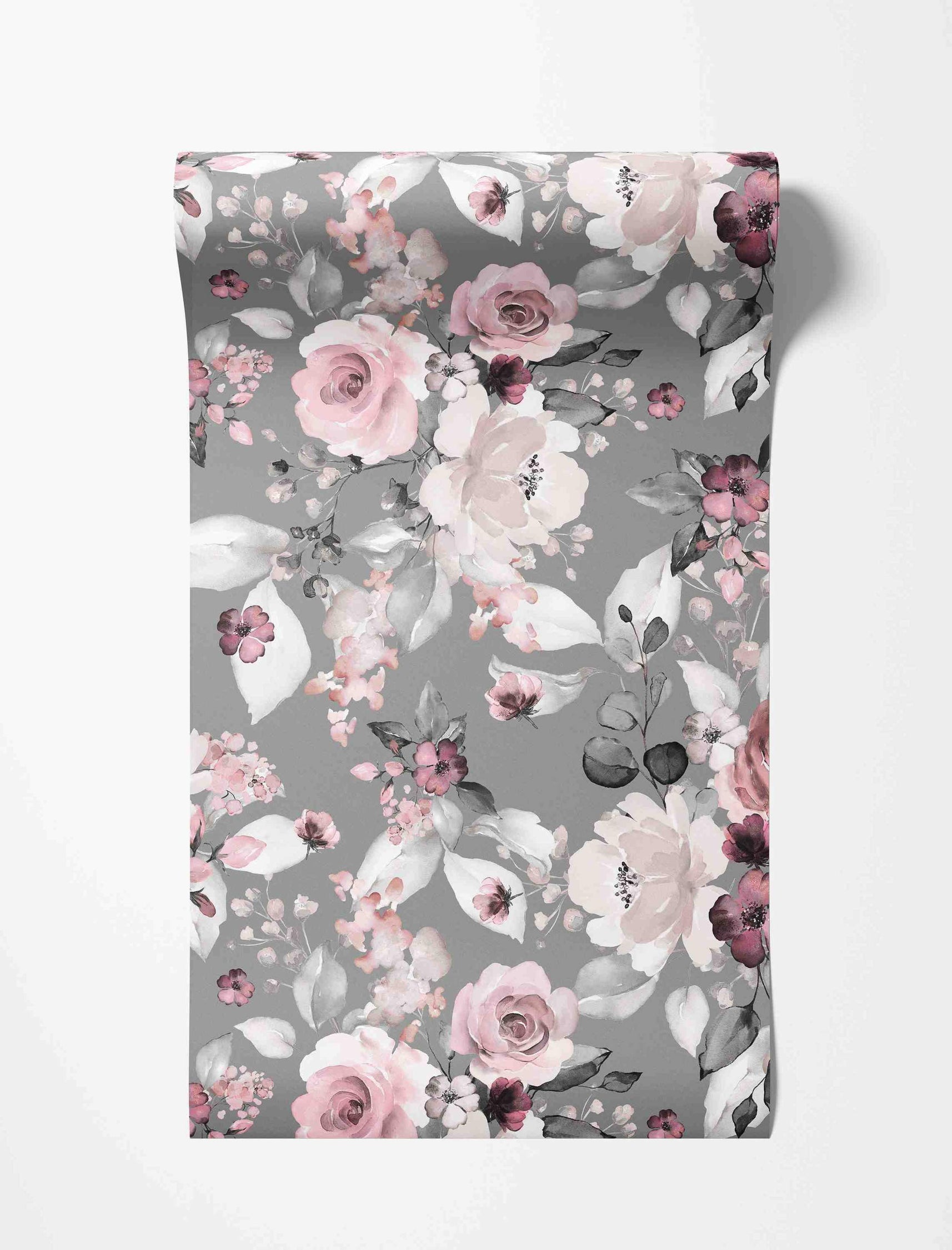 Watercolor floral wallpaper with pink, mauve, and white flowers and grey leaves scattered across a muted grey background.