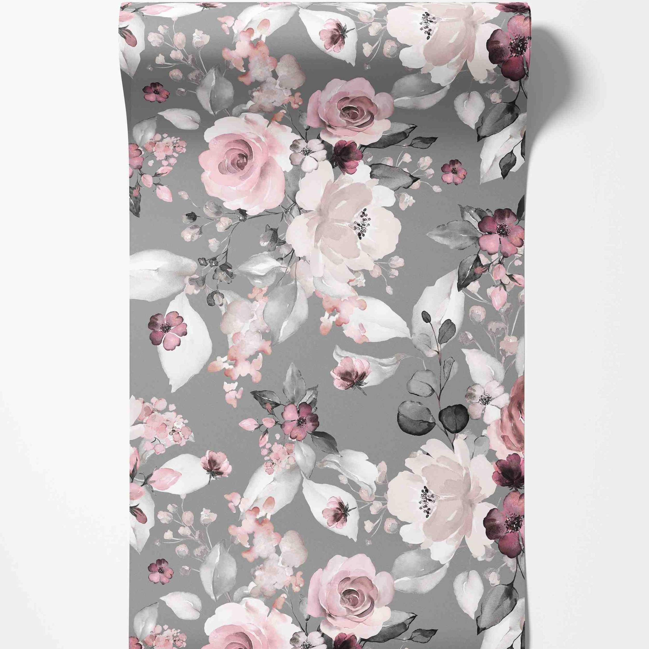 Watercolor floral wallpaper with pink, mauve, and white flowers and grey leaves scattered across a muted grey background.