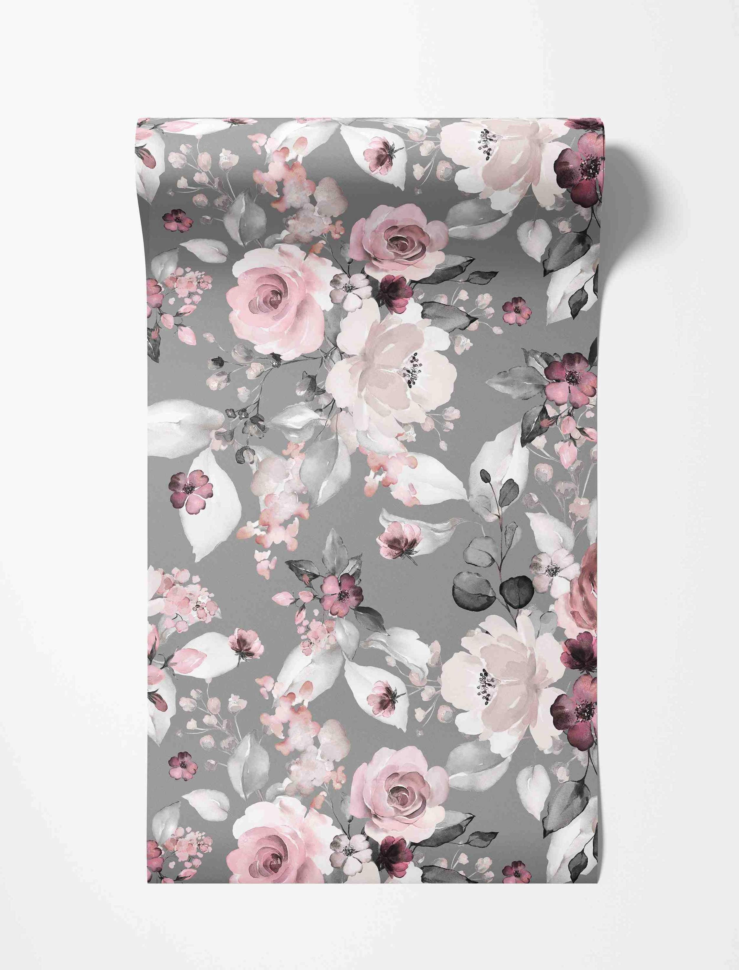 Watercolor floral wallpaper with pink, mauve, and white flowers and grey leaves scattered across a muted grey background.