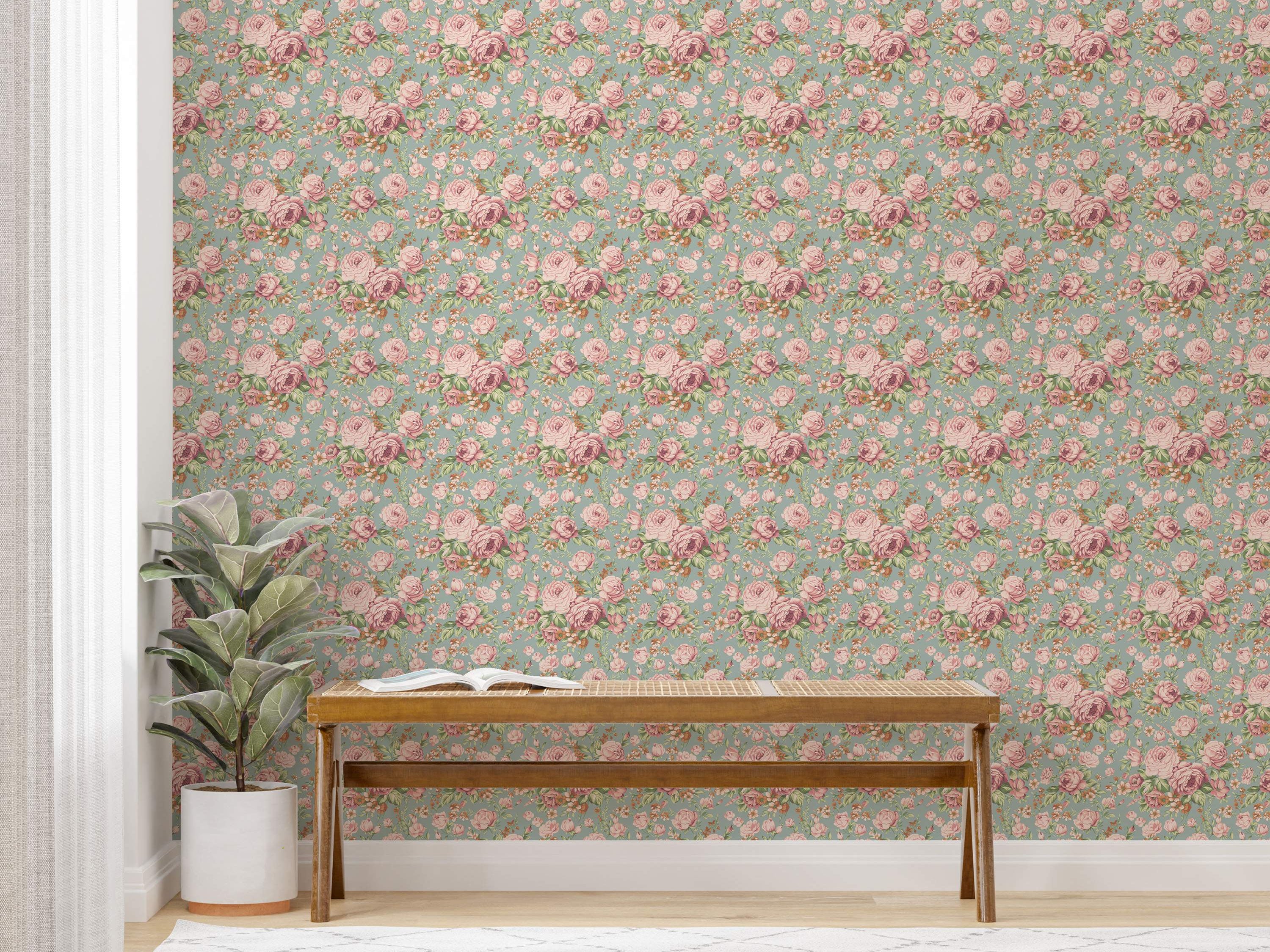 Vintage floral wallpaper with repeating clusters of pink roses and smaller accent flowers on a soft teal background.