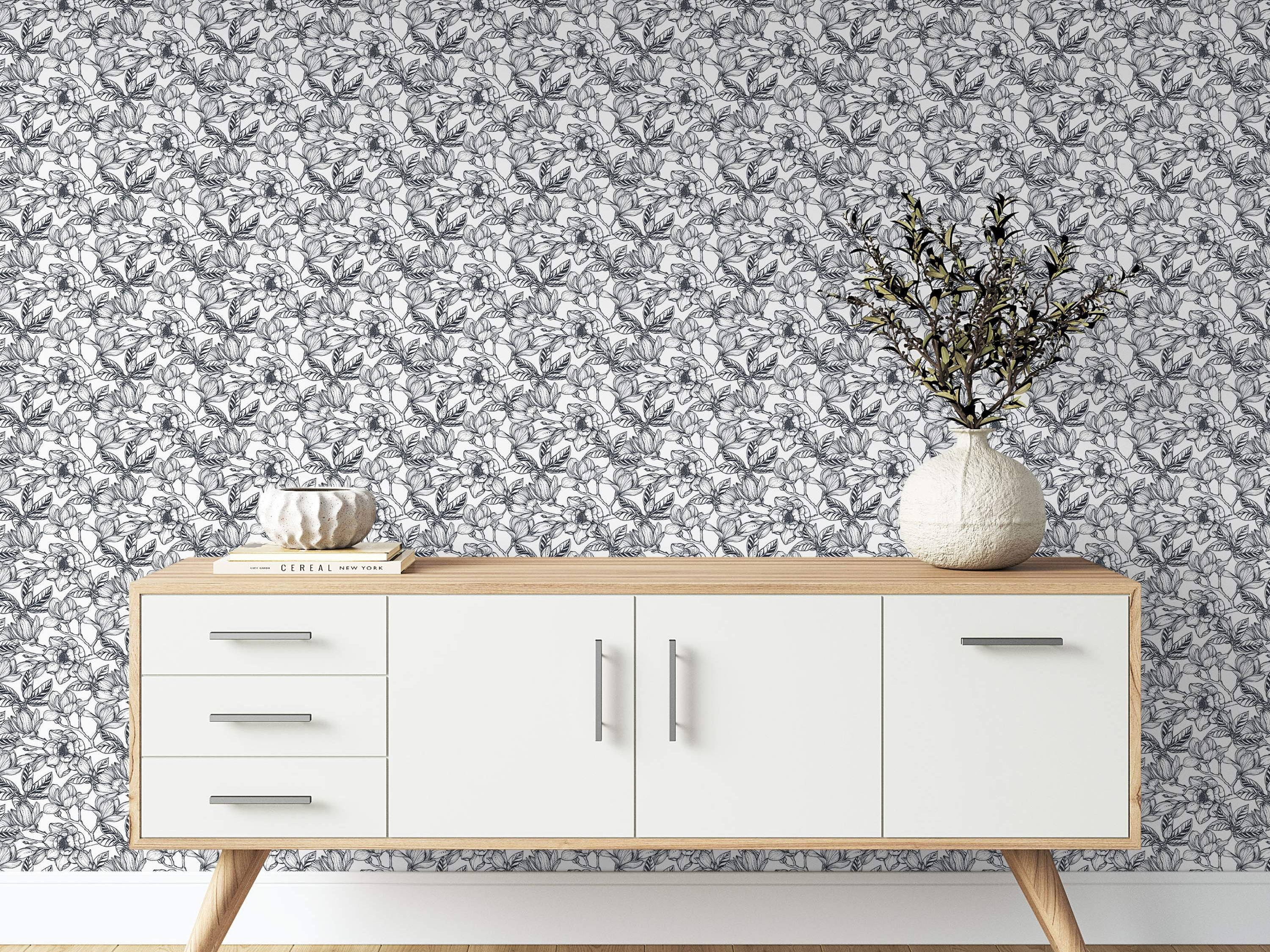 Monochrome wallpaper featuring a dense, sketch-style pattern of large flowers and leaves in black lines on a white background.