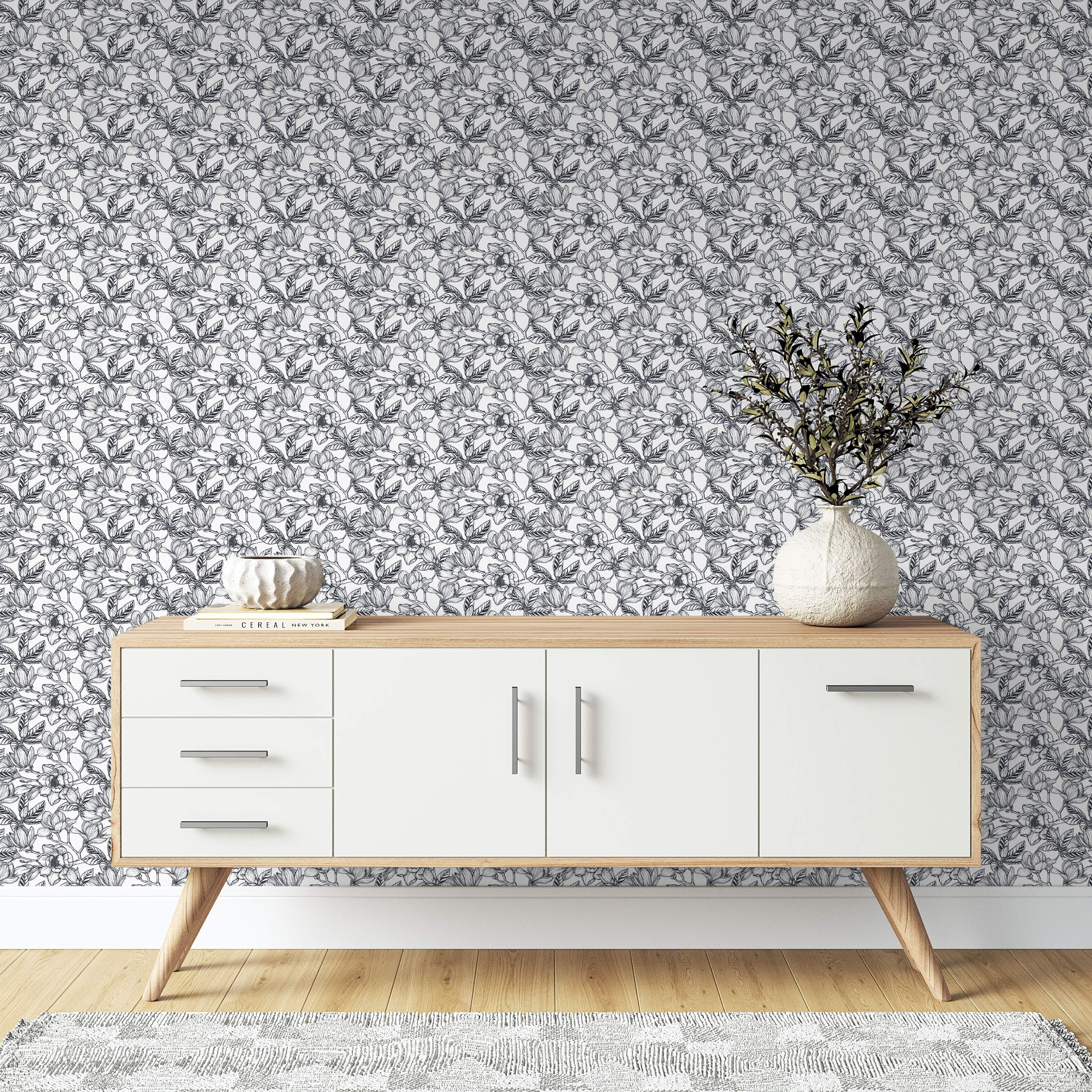 Monochrome wallpaper featuring a dense, sketch-style pattern of large flowers and leaves in black lines on a white background.
