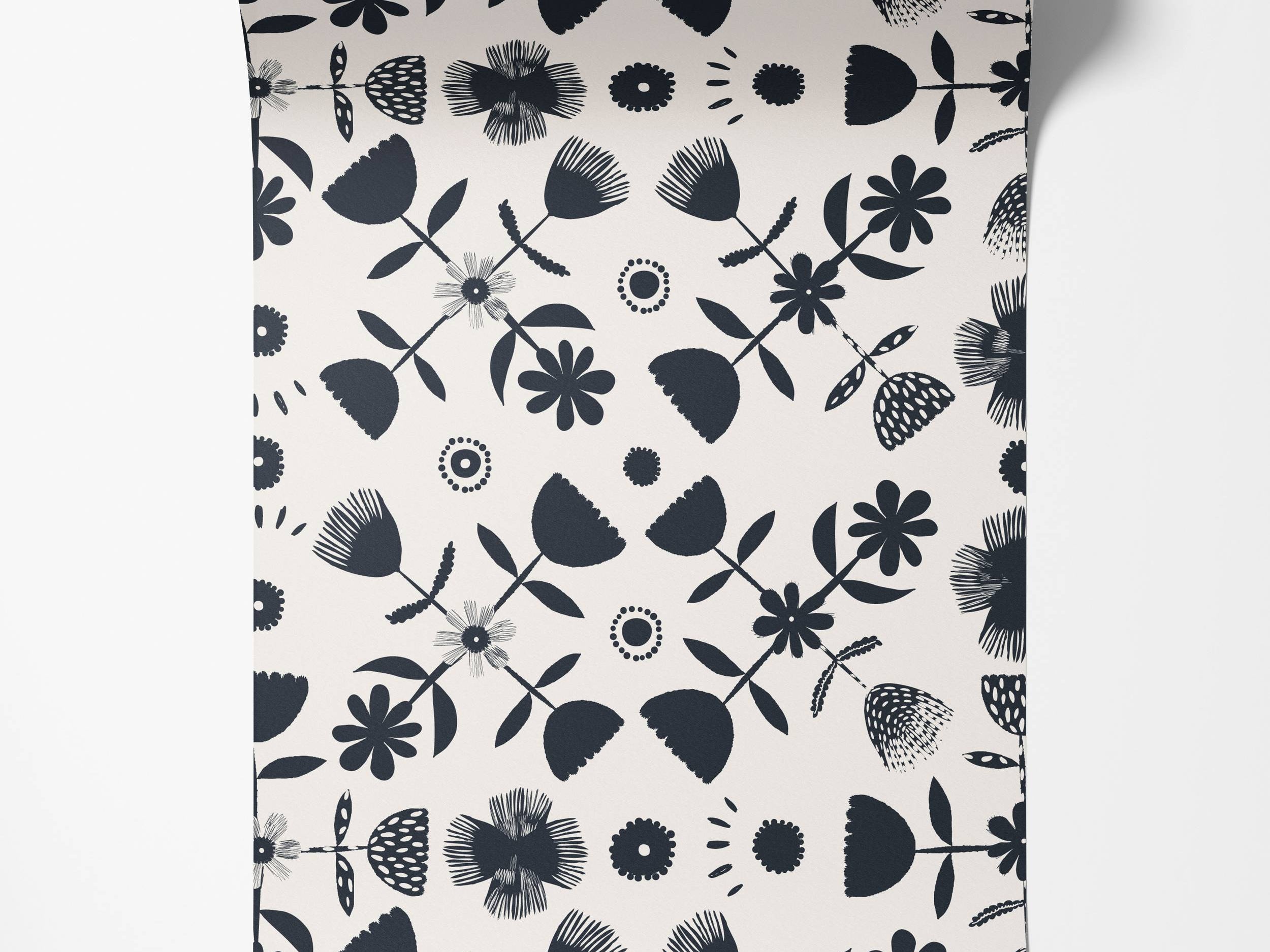 Wallpaper with a Scandinavian-style floral pattern in black silhouettes on an off-white background, featuring various stylized flowers.