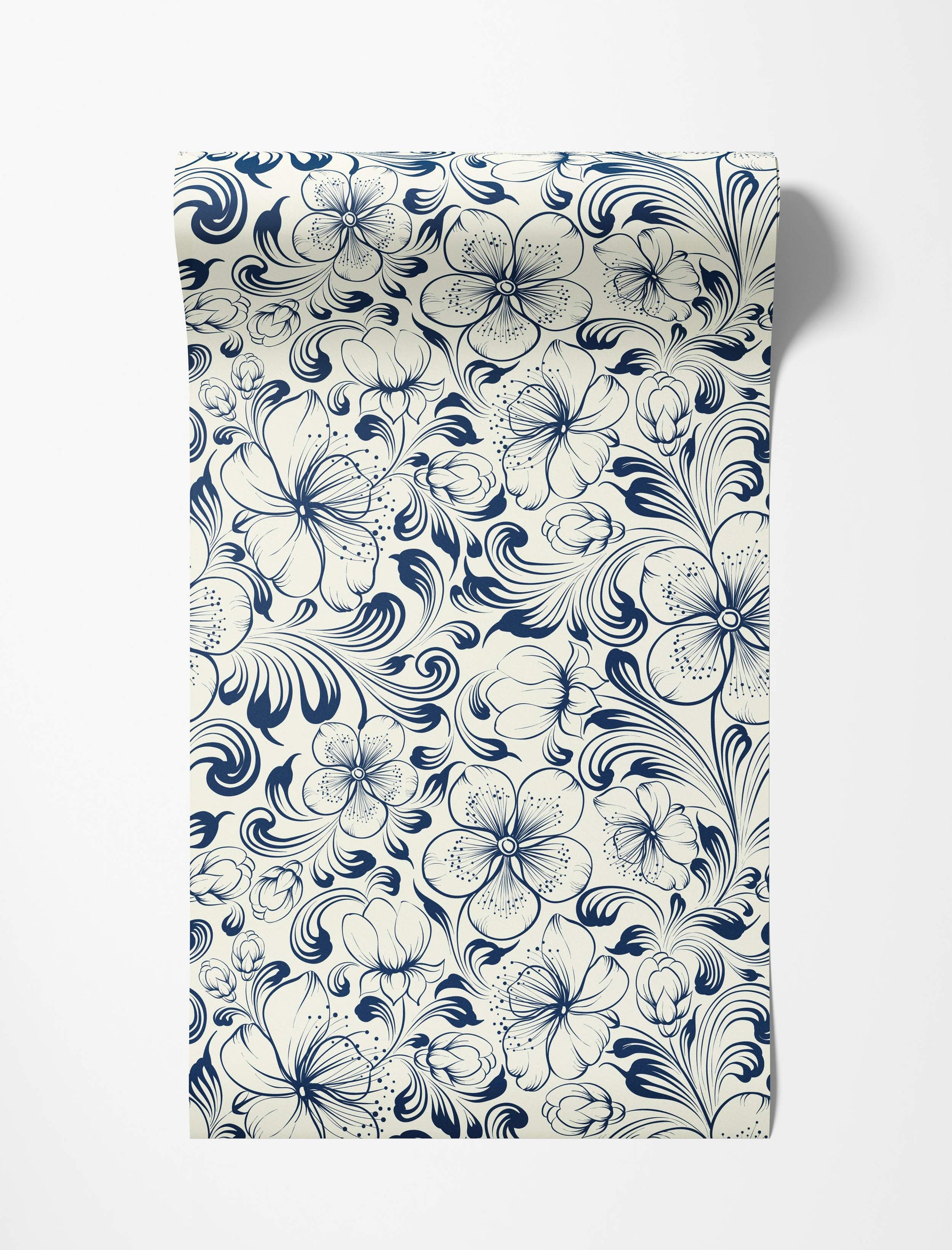 Blue stylized floral vine wallpaper with swirling leaves and flowers detailed with linework on a cream background.