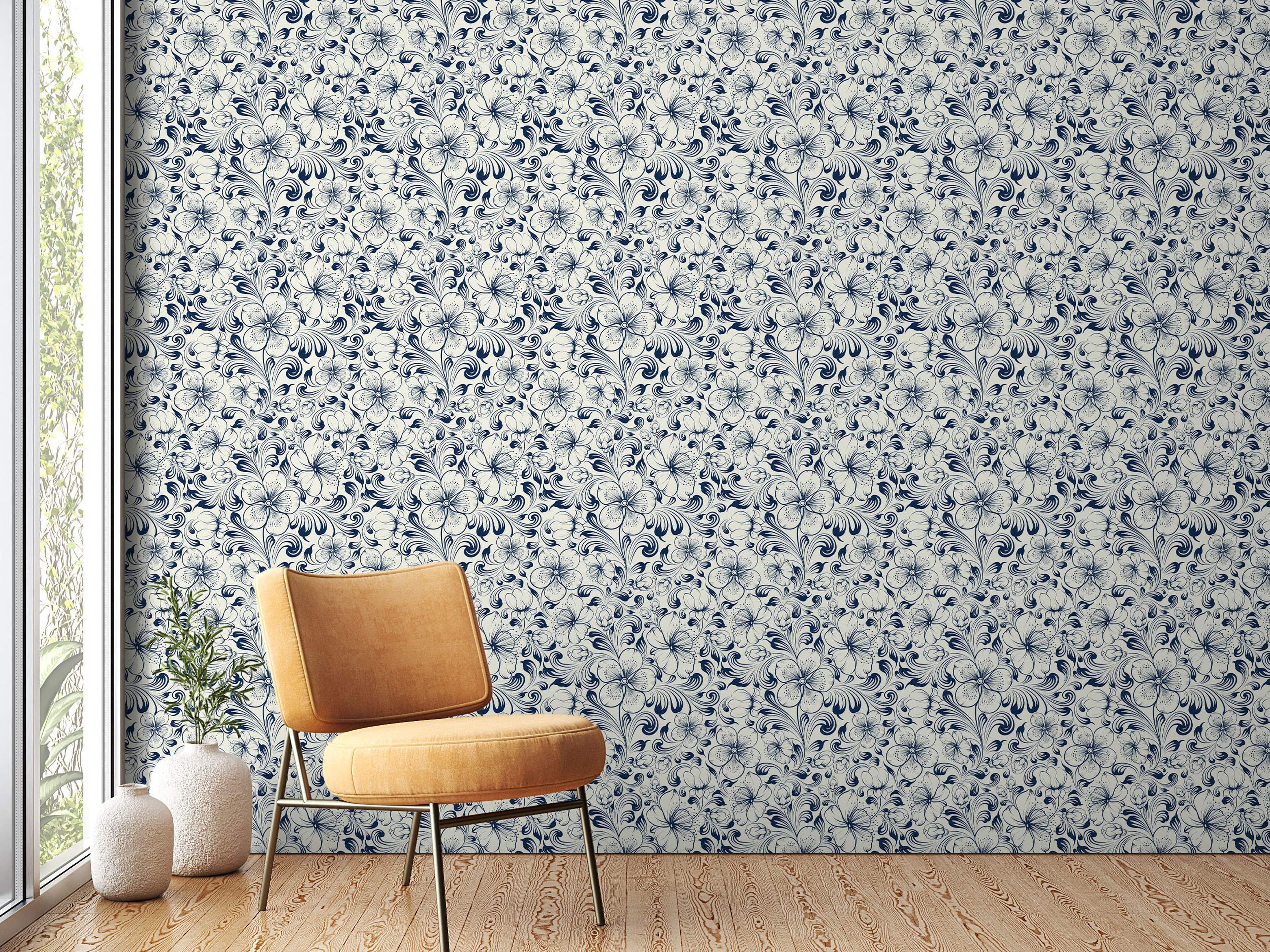 Intricate floral wallpaper featuring navy blue outlined flowers and swirling vines on a cream background.