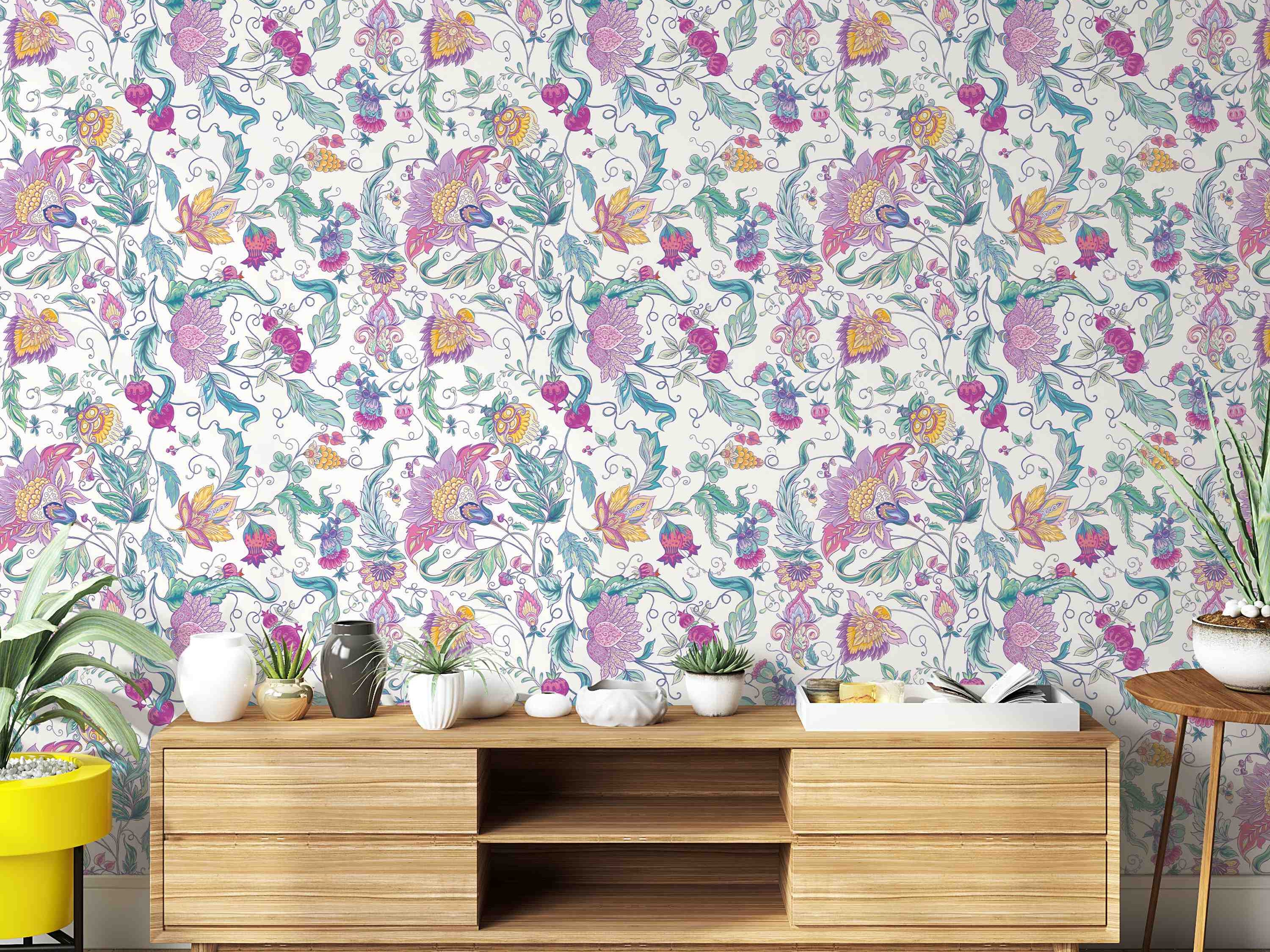 Intricate floral vine wallpaper with pink, purple, yellow, and green stylized flowers and leaves on a light background.