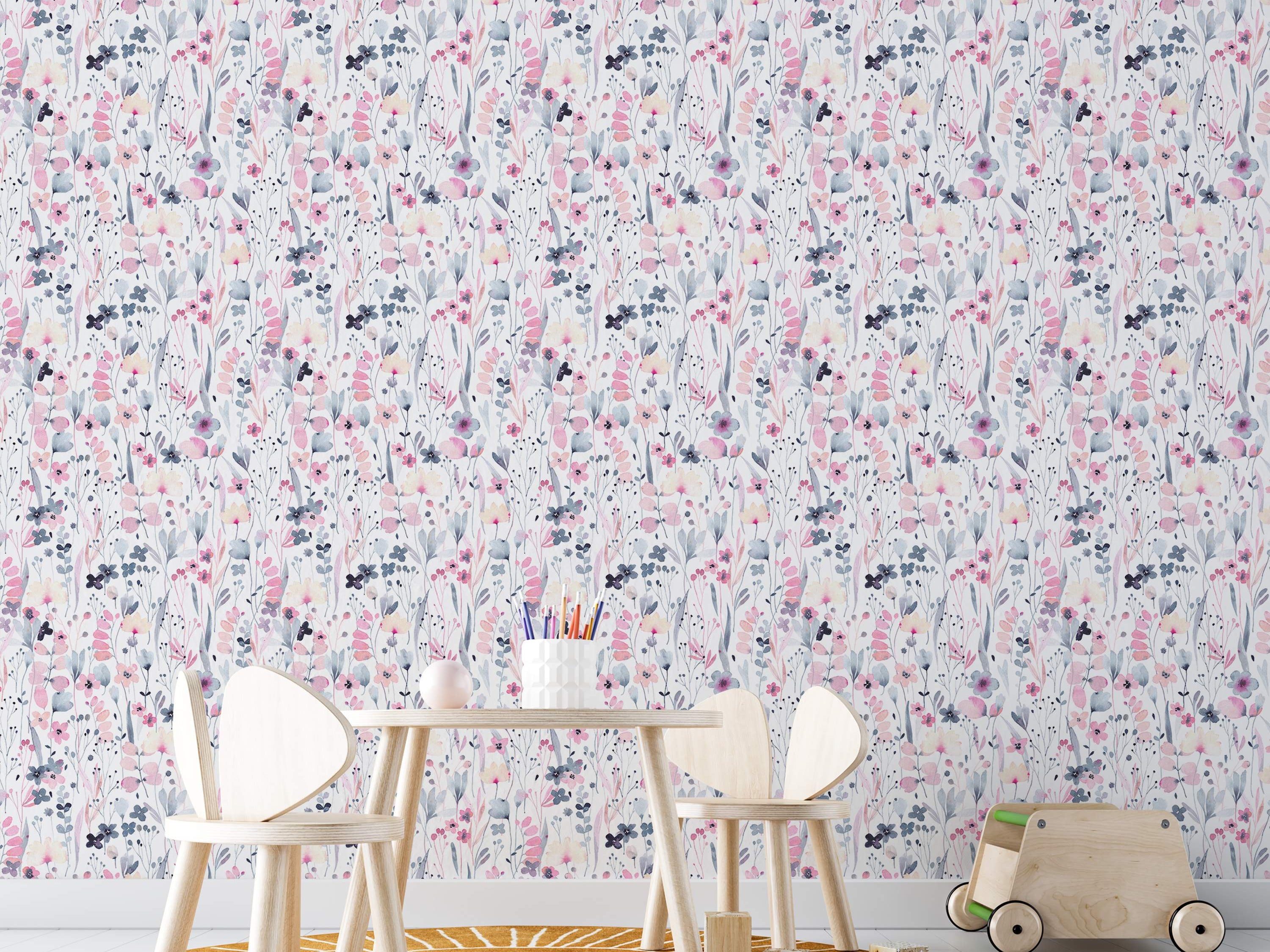 Delicate watercolor floral wallpaper with pink, grey-blue, and pale yellow flowers and leaves scattered on a white field.