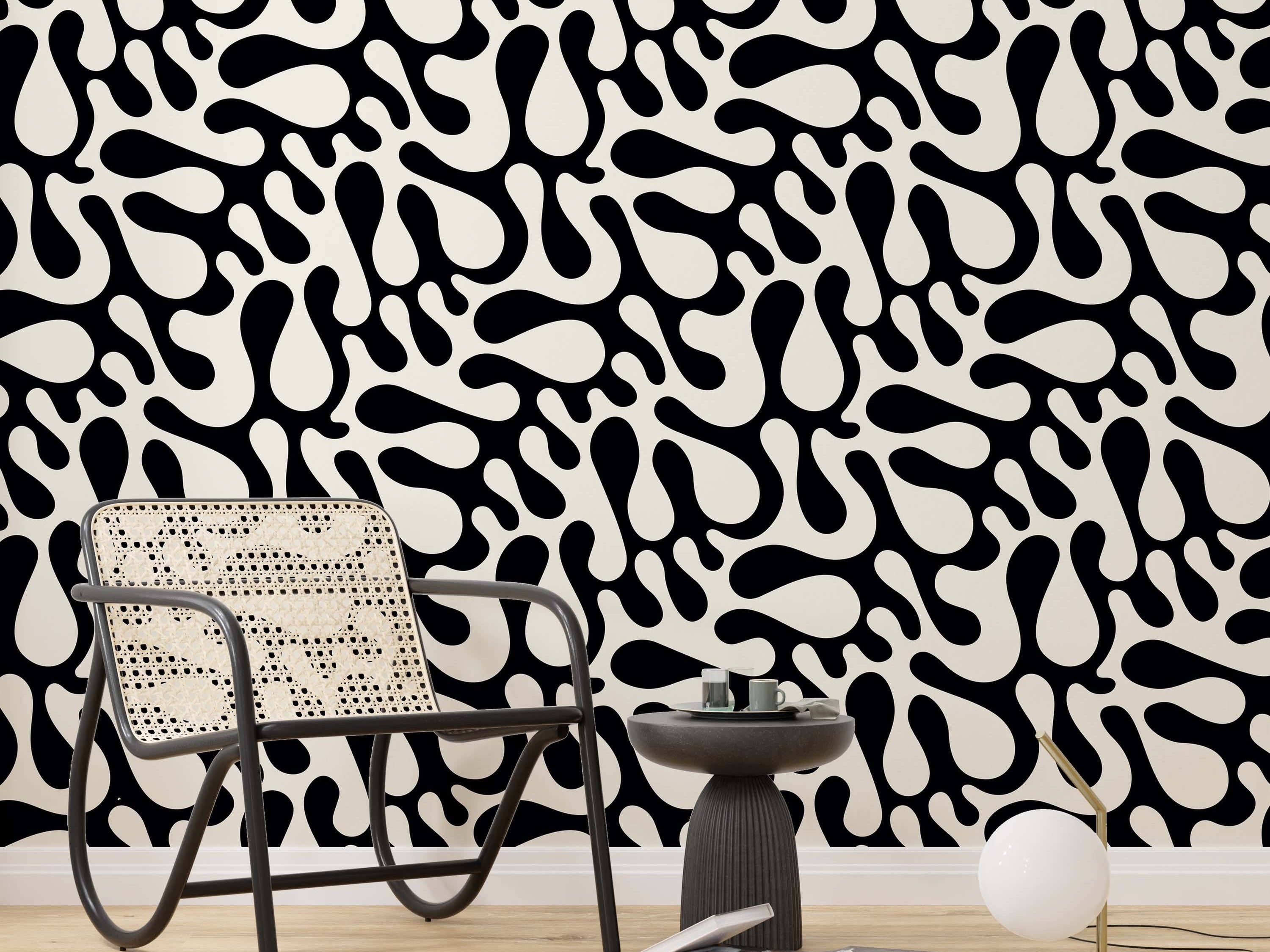 Abstract wallpaper with large, flowing black organic shapes contrasted against a cream background.