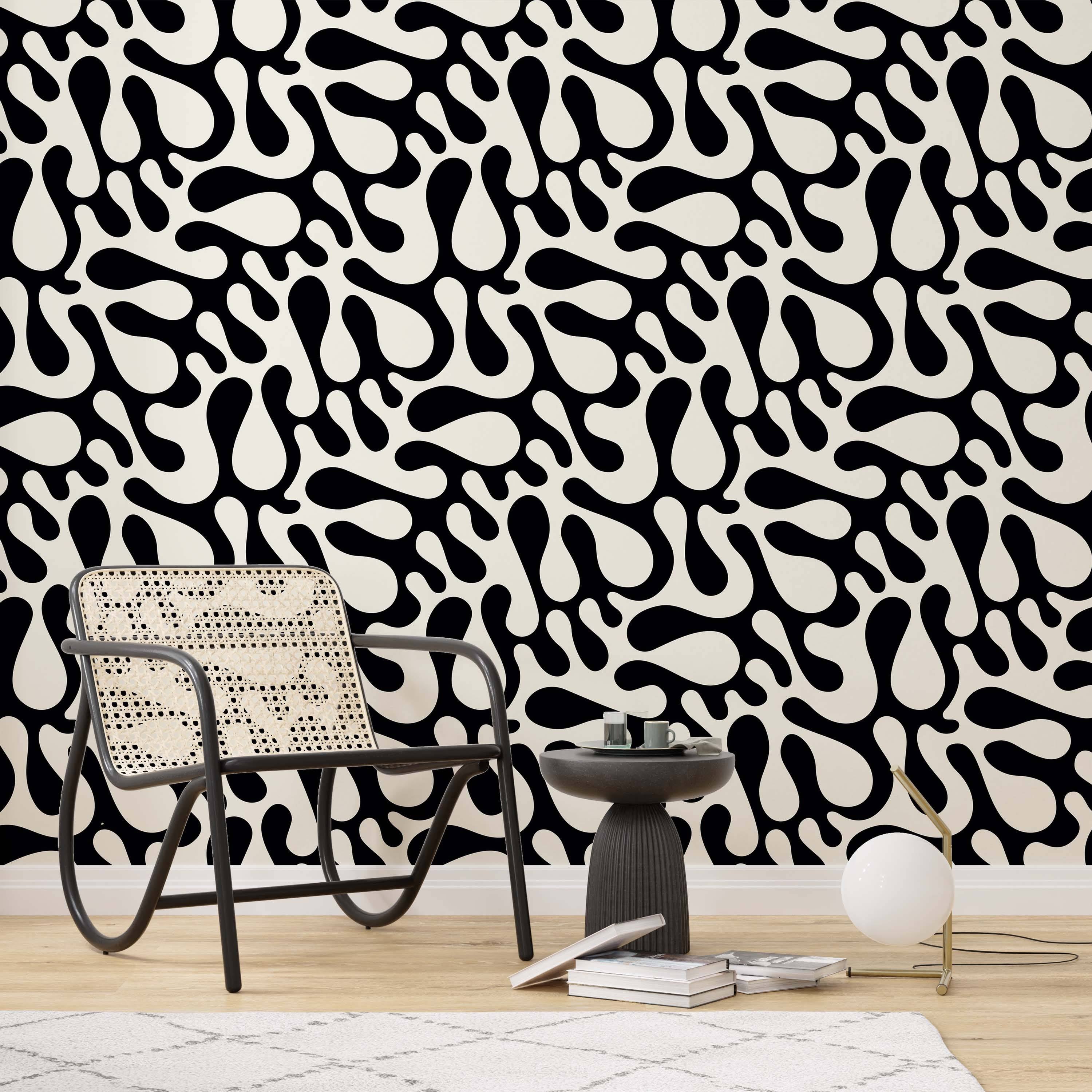 Abstract wallpaper with large, flowing black organic shapes contrasted against a cream background.