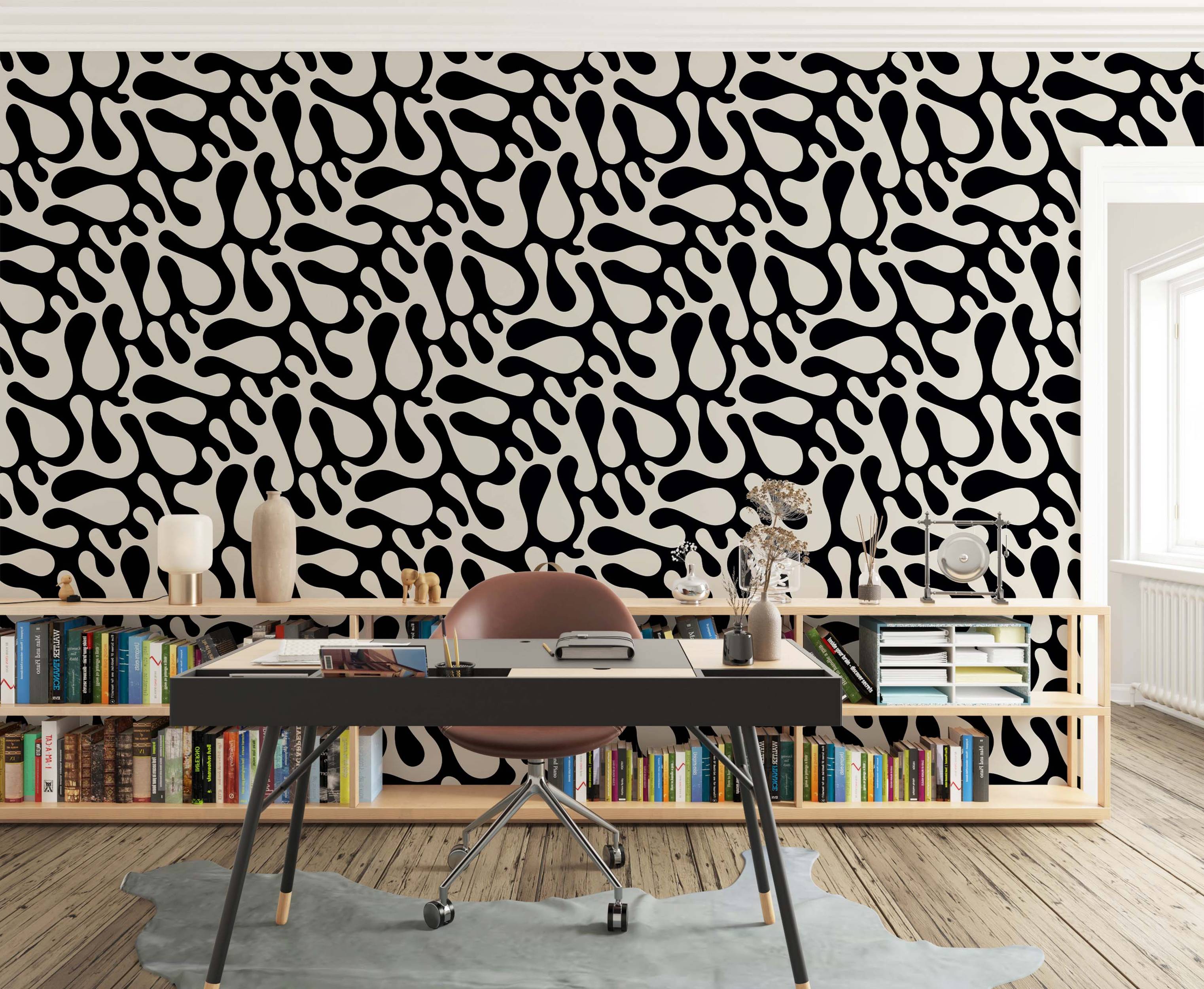 Wallpaper featuring large, abstract, amorphous black fluid shapes scattered across a pale off-white background.